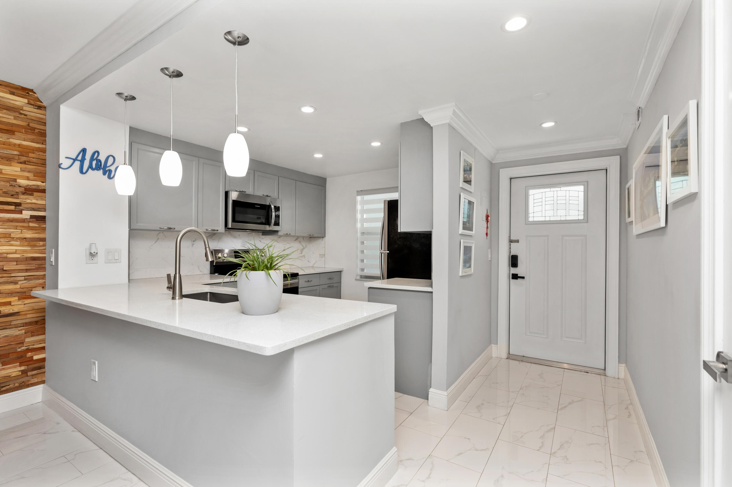 JUST BRING YOUR TOOTHBRUSH! This beautifully updated corner unit in the heart of Boca Raton is the definition of move-in ready. Every detail has been thoughtfully renovated, featuring modern tile flooring throughout, a stunning kitchen w/ quartz countertops, tile backsplash, light gray cabinetry, & stainless steel appliances. The dining area is highlighted by a designer wood accent wall, while crown molding & updated bathrooms add a refined touch. Relax on the spacious enclosed balcony overlooking peaceful canal views framed by swaying coconut trees. Available fully furnished, making your move effortless. Community amenities include a clubhouse & pool, all in a prime central Boca location just minutes from shopping, dining, beaches, & major roadways. Don't miss this exceptional opportunity