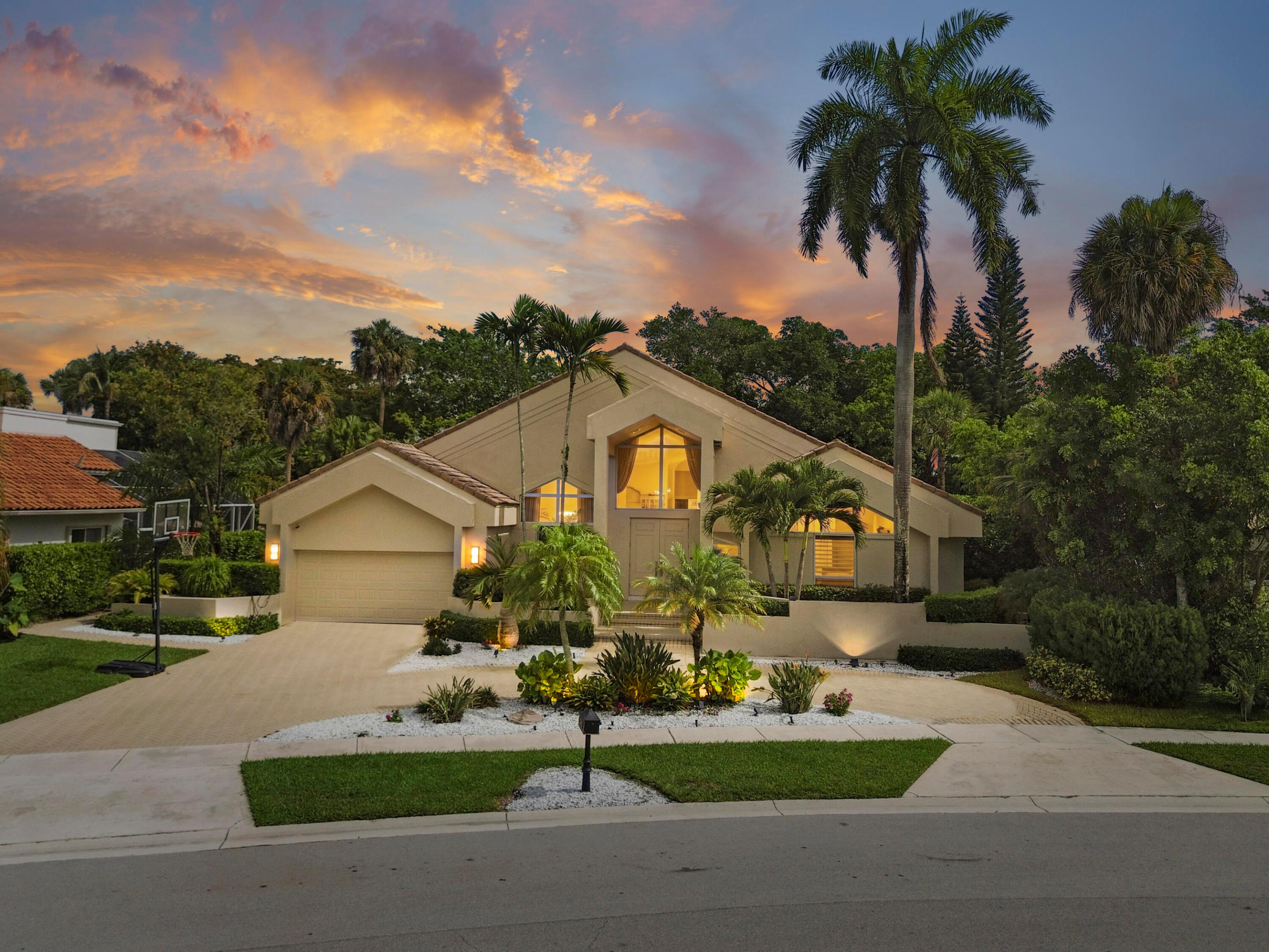 Welcome to Encantada, a family-oriented gated community, with each home built unique, offering elegance, comfort, and resort-style living. Ideally situated in central Boca Raton, Encantada is known as the estate community of Boca Pointe, a non-mandatory Country Club! This stunning one-story contemporary home features 4 bedrooms, 3 bathrooms, and 3342 square feet of living space including a loft. A circular driveway with attached 2-car garage and lush tropical landscaping create impressive curb appeal. Step inside to an open-concept design highlighted by soaring ceilings, a dramatic spiral staircase, and expansive sliding glass doors that seamlessly connect the indoor living areas to the pool and outdoor entertaining spaces. The modern interior showcases clean architectural lines complemented by vibrant accents throughout. The spacious kitchen is designed for both everyday living and entertaining, featuring ample cabinetry, appliances and generous countertop space with breakfast bar seating. A cozy breakfast nook and dedicated bar area provide additional gathering spaces for family and guests. The home also includes a laundry room with a utility sink, washer, and dryer for added convenience. The luxurious primary suite offers a private retreat with pool access, a large Jacuzzi tub, dual sinks, and a frameless glass shower. Upstairs, there is a versatile loft space with a comfortable seating area. Outdoor living is equally impressive, featuring a sparkling free form swimming pool, an open patio, a summer kitchen with a barbecue, refrigerator and sink, cabana bathroom, perfect for hosting gatherings or enjoying Florida's beautiful weather year-round. This exceptional Encantada residence combines sophisticated design, functional living spaces, and outstanding amenities in this sought-after development. Recent upgrades include: pool pump and salt system (2025), 2 new HVAC units (2024), EV car charging port (2021), 4 person hot tub (2021), generator house hookup (2021), new skylights (2020).