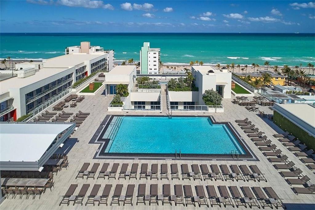 Luxurious corner condo with a large private wrap around balcony facing east to the ocean.  Just a stone's throw to the world famous Hollywood Beach Broadwalk & ideally located 2 blocks from the popular Margaritaville Resort & Hollywood Beach's best attractions! This beautifully furnished condo, built in 2017, features high end tiled floors, a European-inspired kitchen & bath, & is located within a building offering true resort style amenities!  Enjoy a state-of-the-art fitness center, 24 hr concierge, a magnificent roof top pool w/on site dining at the bar & grill, with breathtaking views of the Ocean & the Waterway. The unlimited rental policy offers flexibility for personal use and a rental income, an excellent investment to own one of the most desirable destinations in South Florida!