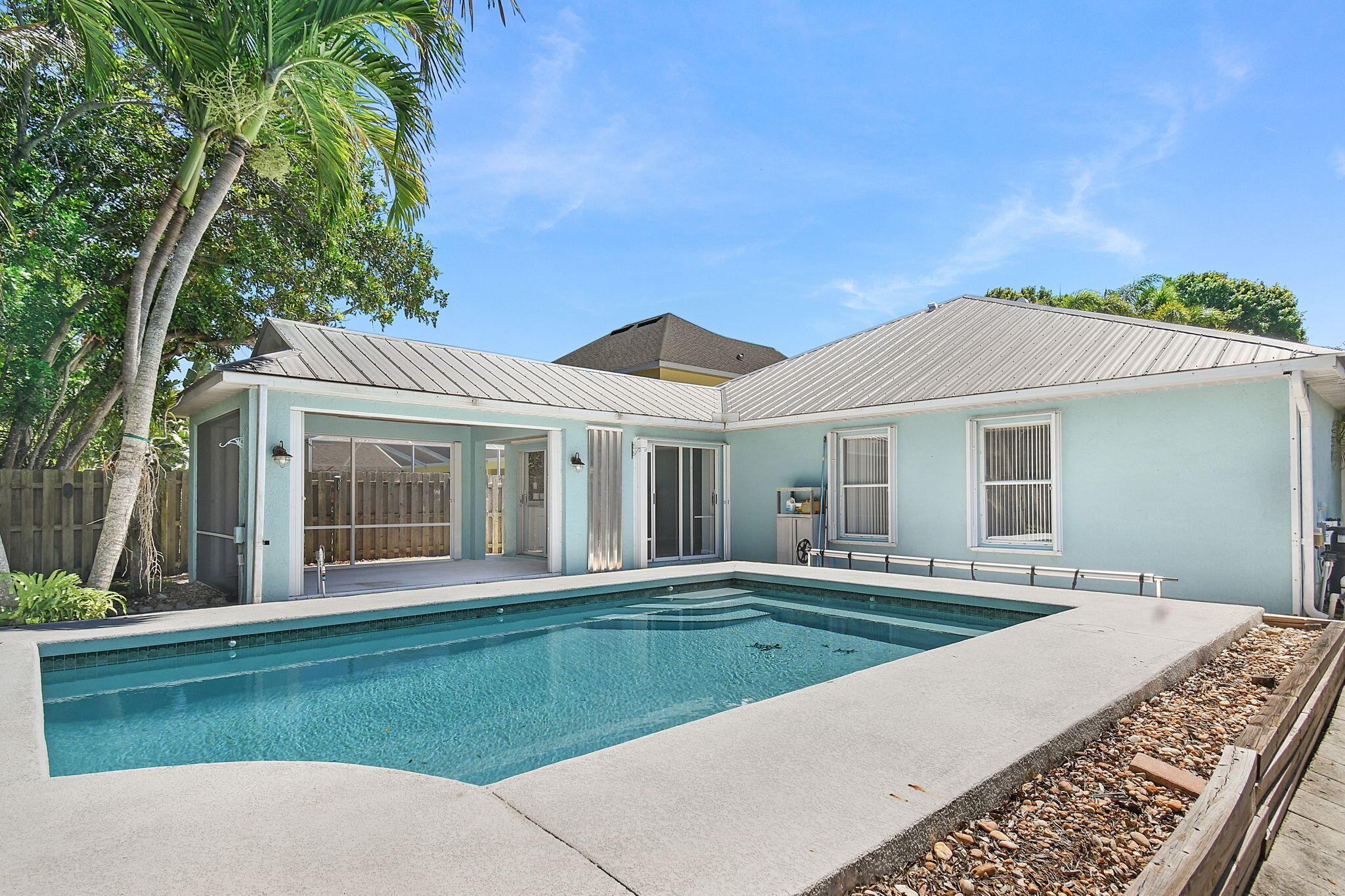 This beautiful 4-bedroom, 2-bath pool home is located in the highly desirable Pineapple Plantation community. Meticulously maintained, this home offers both comfort and style throughout. The remodeled and expanded kitchen provides endless counter space, making it a dream for baking enthusiasts and home chefs alike. The spacious primary suite features a luxurious bath with a deep soaking tub and a walk-in shower, creating a true private retreat. The home features ceramic tile and vinyl plank flooring for easy maintenance & modern appeal. Step outside to enjoy the inviting saltwater pool, perfect for summer relaxation. The covered cabana, complete with a cedar tongue-and-groove ceiling, offers an ideal space for entertaining. Accordion shutters provide added peace of mind.  Conveniently located near shopping, dining, beautiful beaches, and A-rated schools, this move-in-ready home is waiting for its new owner.