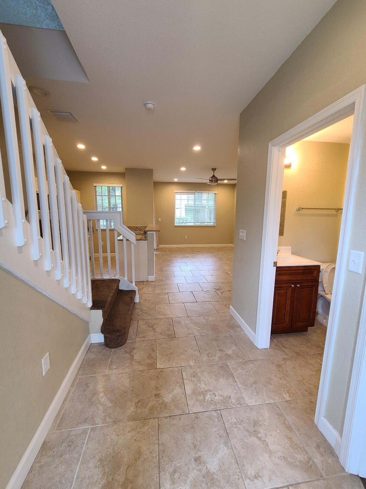 Completely renovated 3-bedroom, 3-bath townhouse featuring tile flooring in the living areas and laminate flooring in all bedrooms. Unique floor plan with a full bathroom for each bedroom. One bedroom and one full bath are located on the first floor, with two additional bedrooms and baths upstairs. The unit includes stainless steel appliances and an in-unit washer and dryer. Located in a 24-hour guard-gated community offering resort-style amenities including a pool, spa, clubhouse, fitness center, tennis courts, playgrounds, and scenic lake walking paths. Conveniently located just minutes from the beach, shopping, dining, schools, and major highways. Available for immediate occupancy
