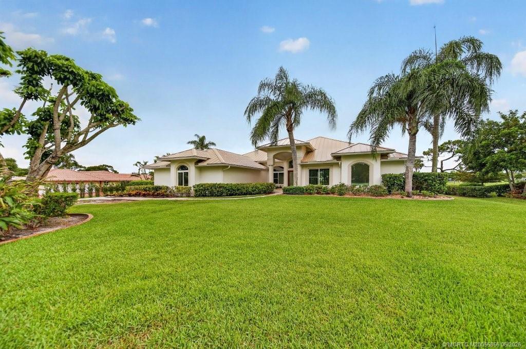 Completely reimagined CBS home w/2020 STANDING SEAM METAL ROOF positioned on PRIVATE 1-ACRE w/MAJESTIC GOLF VIEWS in Palm City. This 5BR/3.5BA residence was renovated down to the studs with nearly every feature replaced or upgraded throughout. NEW IMPACT EVERYTHING, NEW AC systems, NEW drywall, NEW interior doors & hardware, NEW tile flooring throughout, NEW electrical wiring & fixtures, NEW plumbing incl. SMART TANKLESS WATER HEATER, COMPLETE NEW KITCHEN W/QUARTZ COUNTERS; ALL NEW RENOVATED BATHS, FRESH EXTERIOR & INTERIOR PAINT & landscaping, . Whole-house GENERATOR included; & oversized EPOXIED 3-car garage complete this move-in-ready estate. Connected city water with assessment FULLY PAID. Evergreen offers 24HR MANNED GUARD GATE, LOW HOA & NO CLUB MEMBERSHIP REQUIRED (optional/play as  you go). Located in the "A" rated Palm City school zone, minutes to I-95 & Turnpike, beaches, dining & downtown Stuart.