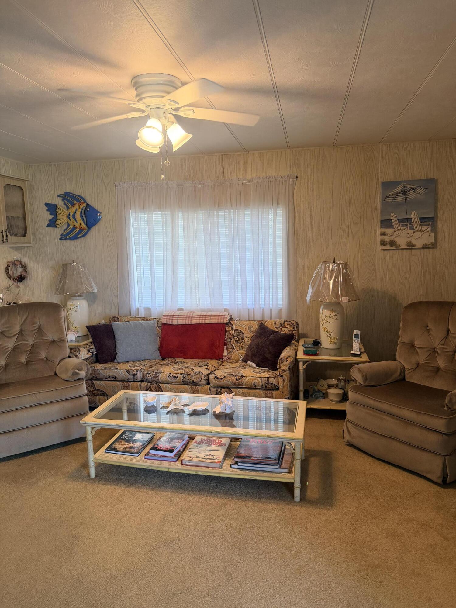 Spacious and well-maintained manufactured home on owned land, offering both comfort & value. Enjoy the large screened Florida room at the front of the home, an inviting space for relaxing, entertaining, or enjoying the Florida lifestyle year-round. Recent updates include a newer A/C (2022), newer water heater (2025), and a brand-new electrical panel currently being installed.  Additional features include a large storage shed, washer and dryer, ample parking, and generous outdoor space. Residents have access to an impressive array of community amenities, including an Olympic-size swimming pool, sauna, fitness center, bowling alley, tennis/pickleball courts & more. Located near shopping, dining, entertainment venues, and major roads with beach access just a short drive away. LAND OWNED
