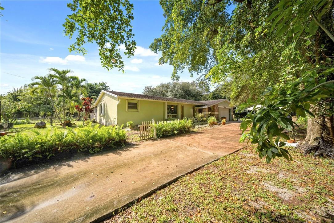 Beautiful deep 2 acres of property with 3 bedroom, 2 bath single family homes nestled in the center of The Town of Davie. Garage with covered screened patio. No HOA, Septic tank on site , large covered screened patio.