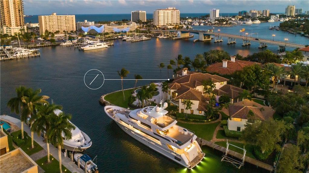 If you attend the boat show this week, do not miss this incredible offering open to the public Friday, Saturday, and Sunday. Presiding over one of the most envied locations in the heart of Fort Lauderdale's world-renowned waterway, this Grand Point Estate is truly a landmark. Located in a no-wake area with panoramic views from its 375 feet of deepwater dockable frontage, peaceful lush gardens, a resort level pool is just the beginning. Built-in 1998, this timeless mansion boasts 8,812 sq. Ft with a detached guest home. 2012 Roof, all impact windows & doors, new HVAC System, two gas fireplaces, a chef's kitchen that opens to the family room, a luxurious master suite w/ dual closets & water closets, an office, and a collection of formal areas a bar. All furniture included in the sale.