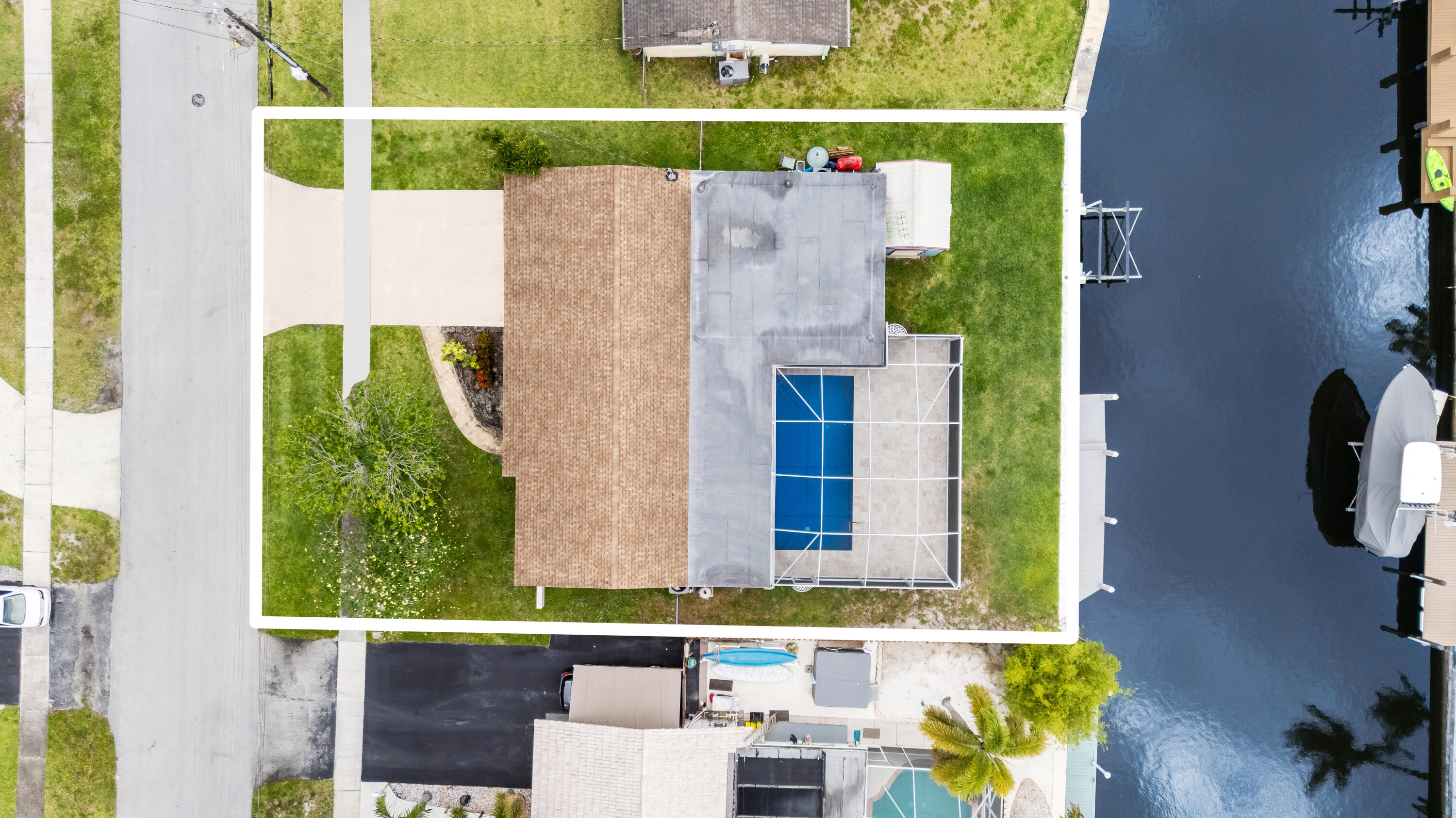 Welcome to Plantation, This home features a fully renovated kitchen completed in 2022 with premium Thomasville cabinetry, sleek quartz countertops, an oversized kitchen island, and 8 LED recessed lights with adjustable controls, creating a bright and sophisticated space ideal for both everyday living and entertaining. Designed to maximize the South Florida lifestyle, the outdoor area was extensively enhanced in 2022 with a resurfaced pool, a 12-foot extended patio, elegant travertine tile, and a panoramic screened enclosure with top hats installed for additional comfort while enjoying the stunning waterfront views. Boating enthusiasts will appreciate the 40-foot dock constructed with recyclable materials, a 10,000-pound boat lift, and an upgraded seawall with a larger cap and extensions. Roof was installed in 2021 4 Ton Air conditioner insalled in 2019 Tanless water heater installed in 2022 Wooden Shed 10X12 3 Zone Sprinklers