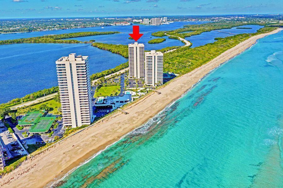 Experience one of Singer Island's most exceptional waterfront residences in the coveted 200 building at Water Glades. Ideally positioned in what many consider the premier stack, Residence 3C showcases breathtaking unobstructed views of the Atlantic Ocean, Intracoastal Waterway, and protected vistas overlooking John D. MacArthur Beach State Park. Enjoy the rare privilege of both spectacular sunrises and glowing sunsets visible directly from your private balcony.  Thoughtfully updated, the kitchen wall has been removed to create an open-concept design that maximizes views, natural light, and flow. Additional highlights include a washer and dryer in the unit and an exceptionally large private storage room exclusive to this residence.   Water Glades is situated on one of the largest and most beautifully maintained parcels on Singer Island, offering a private, wide sandy beach and resort-style amenities including 24/7 security, tennis courts, two pools, a newly renovated clubhouse with full kitchen available for resident use, fitness centers located in each building, shuffleboard, putting green, car wash area, and three grilling stations surrounded by lush, beautifully manicured grounds. A rare opportunity to enjoy privacy, panoramic water views, and one of the island's most sought-after coastal lifestyles.