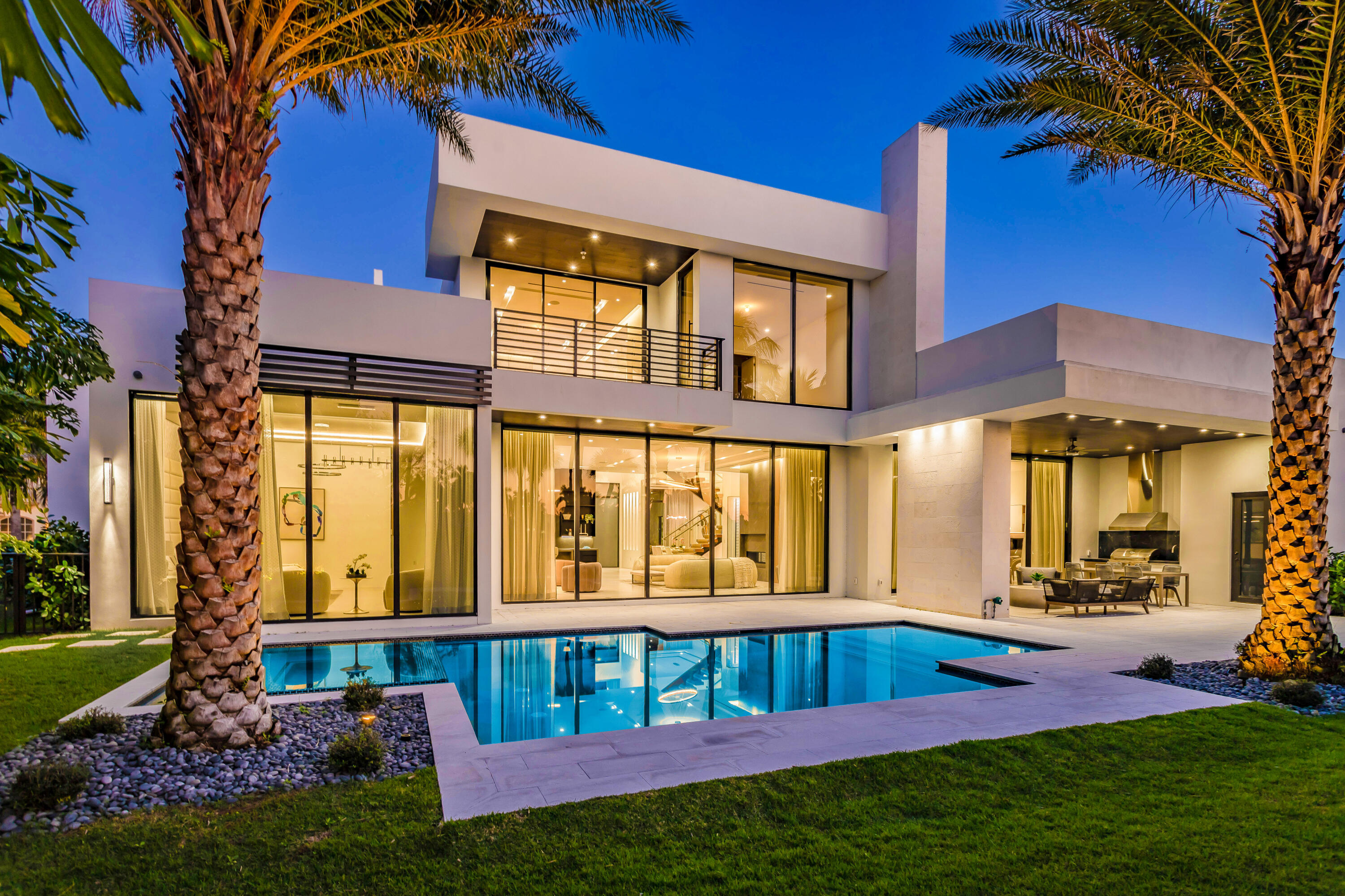 This NEWLY COMPLETED modern luxury home is designer furnished on the first floor complete with furniture, electronics and artwork.  With its exceptional golf course location, the five bedrooms consist of the first floor primary main bedroom with dual bathrooms and walk in closets. A secondary first floor bedroom with en suite bathroom is currently furnished as an office/den with floor to ceiling glass.  An contemporary wood step stairway accesses the second floor which features three expansive bedroom suites with an entertainment/game/television area which opens to a patio balcony overlooking exceptional golf course views. An open pool with infinity spa and patio are in addition to the covered patio and barbecue area.   SEE MORE... All bedrooms are en suite offering balconies, floor to ceiling glass windows, large closets, and beautiful golf course views. With approximately 6,382 air-conditioned sq. feet,  this home provides the highest quality custom finishes throughout including a dramatic floating white oak and glass staircase and a sparkling glass wine wall. The first floor includes an expansive open living room, with wet bar, a spacious dining room and a gourmet quality chef's kitchen, Miele appliances  with large center island overlooking the family room complete with gas fireplace. Outside is a wonderful, covered patio complete with gas fireplace and a cabana bath. There are also two garages. One is a two-car garage and the other is a one-car garage plus room for a golf cart or a sports car.
Ready to move into, this won't last.