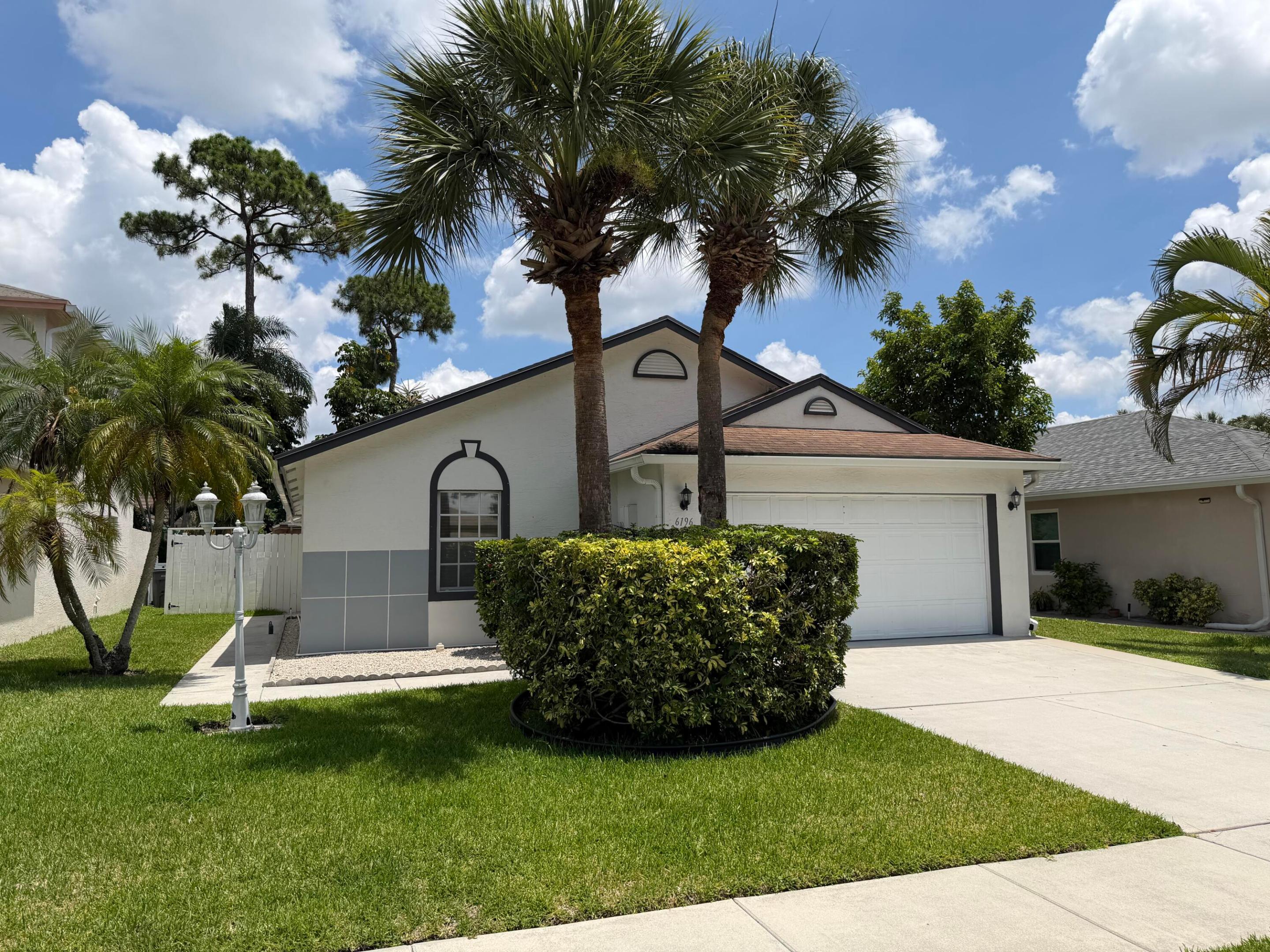 Welcome home to this meticulously maintained and extensively upgraded 3-bedroom, 2-bath residence with a 2-car garage, nestled on a quiet, fully fenced lot in the sought-after gated community of Victoria Woods with low HOA fees. Designed for both comfort and functionality, this move-in-ready home features a bright, open floor plan with vaulted ceilings and diagonal tile flooring throughout - no carpet. The stunning chef-inspired kitchen was completely renovated in 2022 and showcases granite countertops, stainless steel appliances, abundant cabinetry, a custom-built pantry, and a charming breakfast area. The spacious primary suite serves as a private retreat with direct access to the backyard, a walk-in closet plus an additional custom-organized closet system, and an updated ensuite bath  with new cabinetry, countertops, and a linen closet. Both bathrooms were refreshed in 2022 with new vanities, countertops, and toilets.  This home has been thoughtfully enhanced with countless improvements, including full interior and exterior painting (2022), new window blinds (2022), upgraded lighting and wall switches (2022), replaced interior water valves (2022), and custom closet shelving. Modern conveniences include a Smart WiFi Samsung washer and dryer (2023), added laundry utility sink, and a Smart WiFi water heater (2024) with a transferable 20-year warranty. The AC system (2020) was serviced with cleaned coils in 2022, and air ducts were professionally cleaned the same year.  Step outside to enjoy your private outdoor oasis featuring new sod in the front and backyard (2023), a 4-zone programmable sprinkler system with digital controller and individual valves (2023), new fencing (2022), gutters surrounding the entire home (2022), and a custom 6' x 4' storage shed. Additional upgrades include a widened driveway (2024), programmable driveway lighting, and a WiFi-enabled garage door opener with new motor, sensors, and components (2022).  Ideally located just minutes from the Florida Turnpike, I-95, Palm Beach International Airport, Palm Beach Outlets, downtown West Palm Beach, and approximately 8 miles from the beach and Lake Worth Pier, this exceptional property offers the perfect combination of modern upgrades, convenience, and Florida living at its finest.
