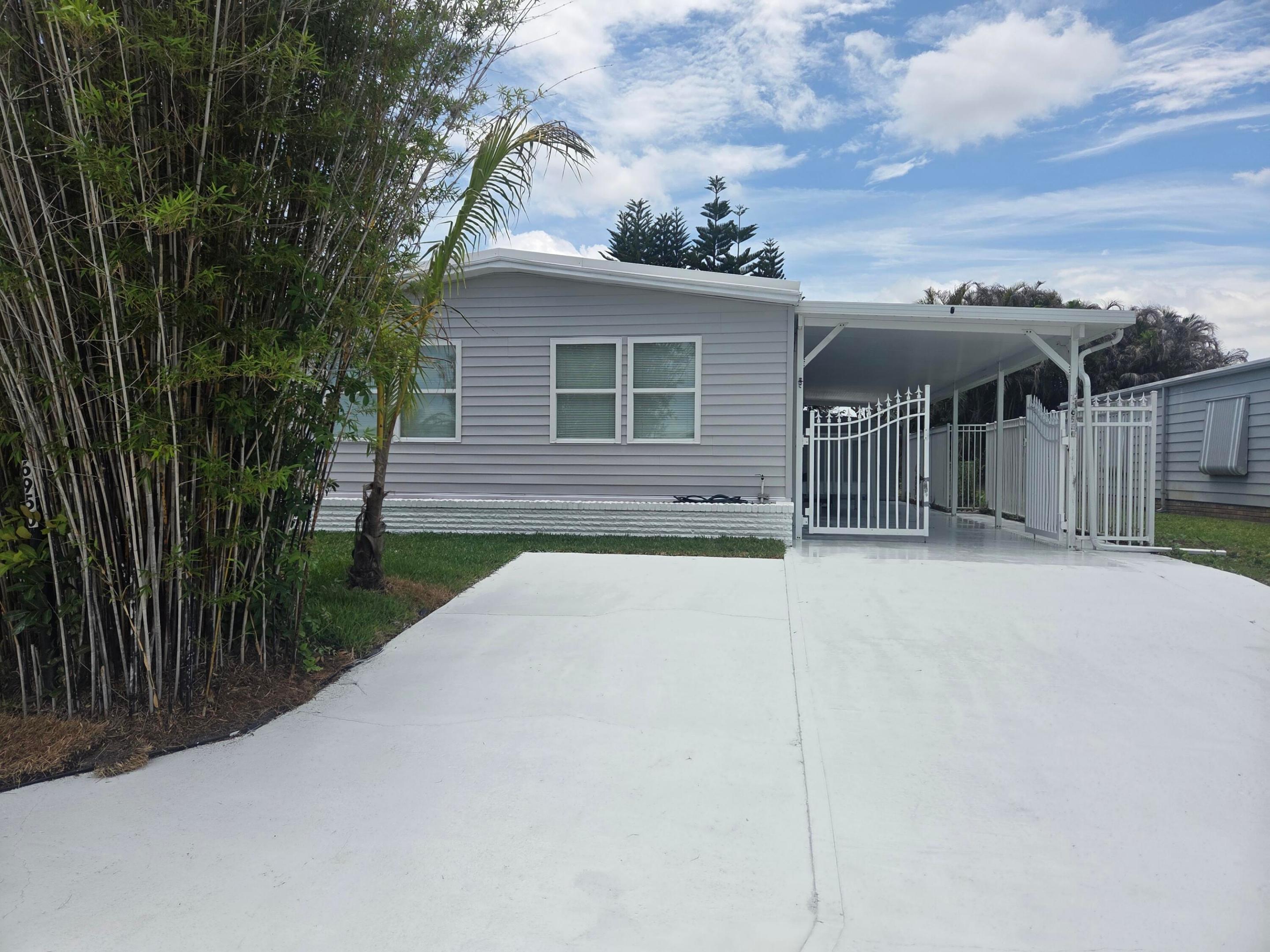 This fully renovated three-bedroom, two-bath manufactured home has been transformed from top to bottom. Every surface and system has been refreshed to modern standards. The exterior features new siding and windows, giving the home fresh curb appeal and improved insulation. Inside, the original paneling has been replaced with smooth sheetrock walls, complemented by new flooring and modern lighting throughout, creating a bright, contemporary feel. The kitchen showcases brand-new cabinets, appliances, and updated electrical and plumbing systems, making it as functional as it is stylish. Both bathrooms are completely new, offering updated fixtures, vanities, and finishes. With all new infrastructure—from wiring to plumbing—this renovation delivers the comfort and reliability of a new home. 2013 Roof was silicon coated in 2026