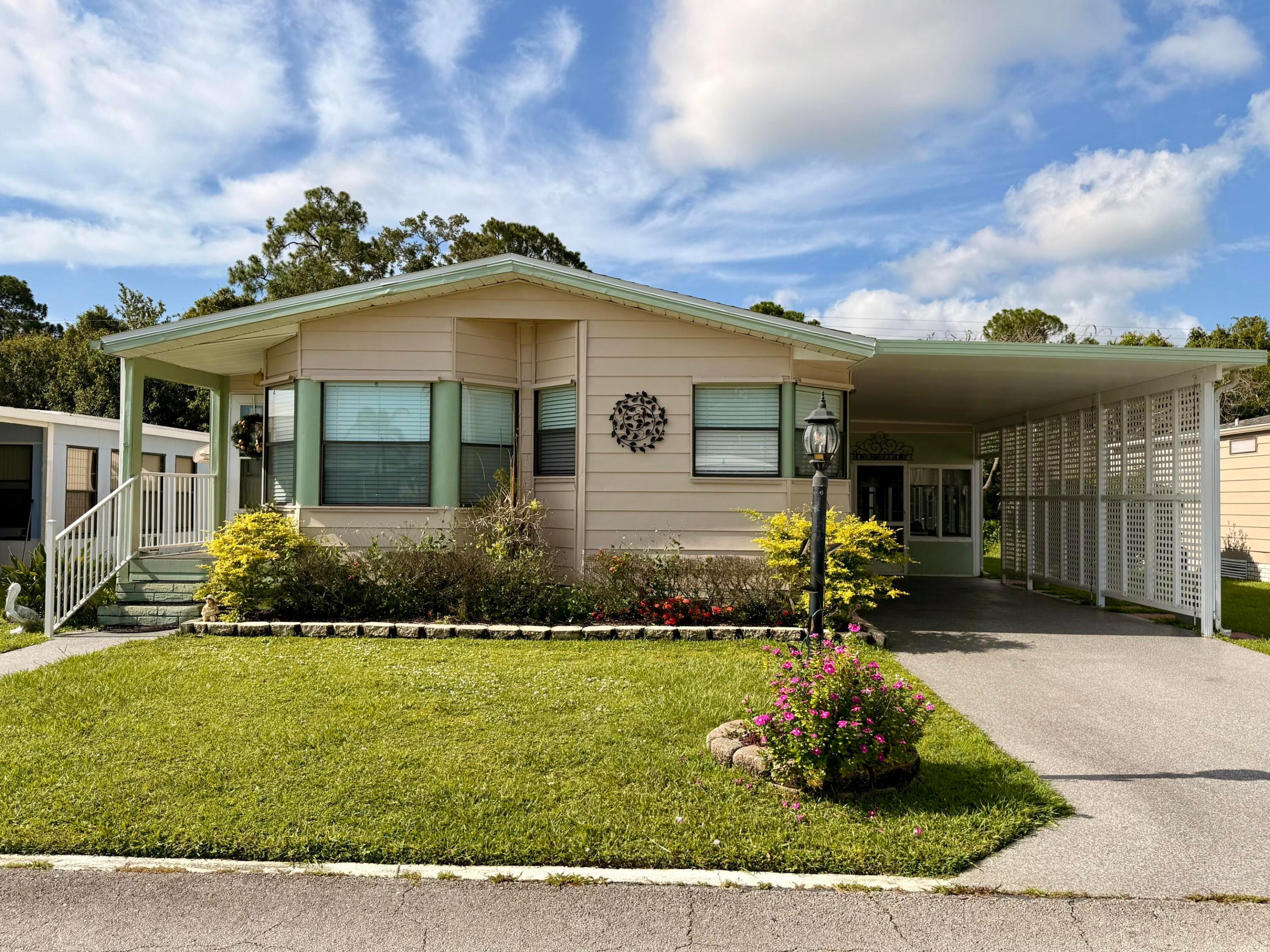 Welcome to this charming 2-bedroom, 2-bathroom manufactured home nestled in the La Buona Vita community of Port St. Lucie, Florida. This 55+ community offers a delightful blend of small-town charm and close to city conveniences. Step inside to discover a spacious great room that seamlessly transitions into a formal dining room. The large kitchen features a cook top stove, wall oven and tons of counter space!  Off the kitchen features a sitting area or breakfast nook for that added space.  Adjacent to the sunroom is a spacious laundry room equipped with a wheelchair ramp and an exterior covered patio. The fenced-in yard in the pet section of this community is a haven for pet owners, offering a lush green backdrop. This home boasts a 2026 Roof, Driveway Coating, and exterior paint, ensuring  its longevity and curb appeal. Conveniently located near restaurants, shopping centers, and other amenities, the La Buona Vita community provides residents with a vibrant lifestyle.