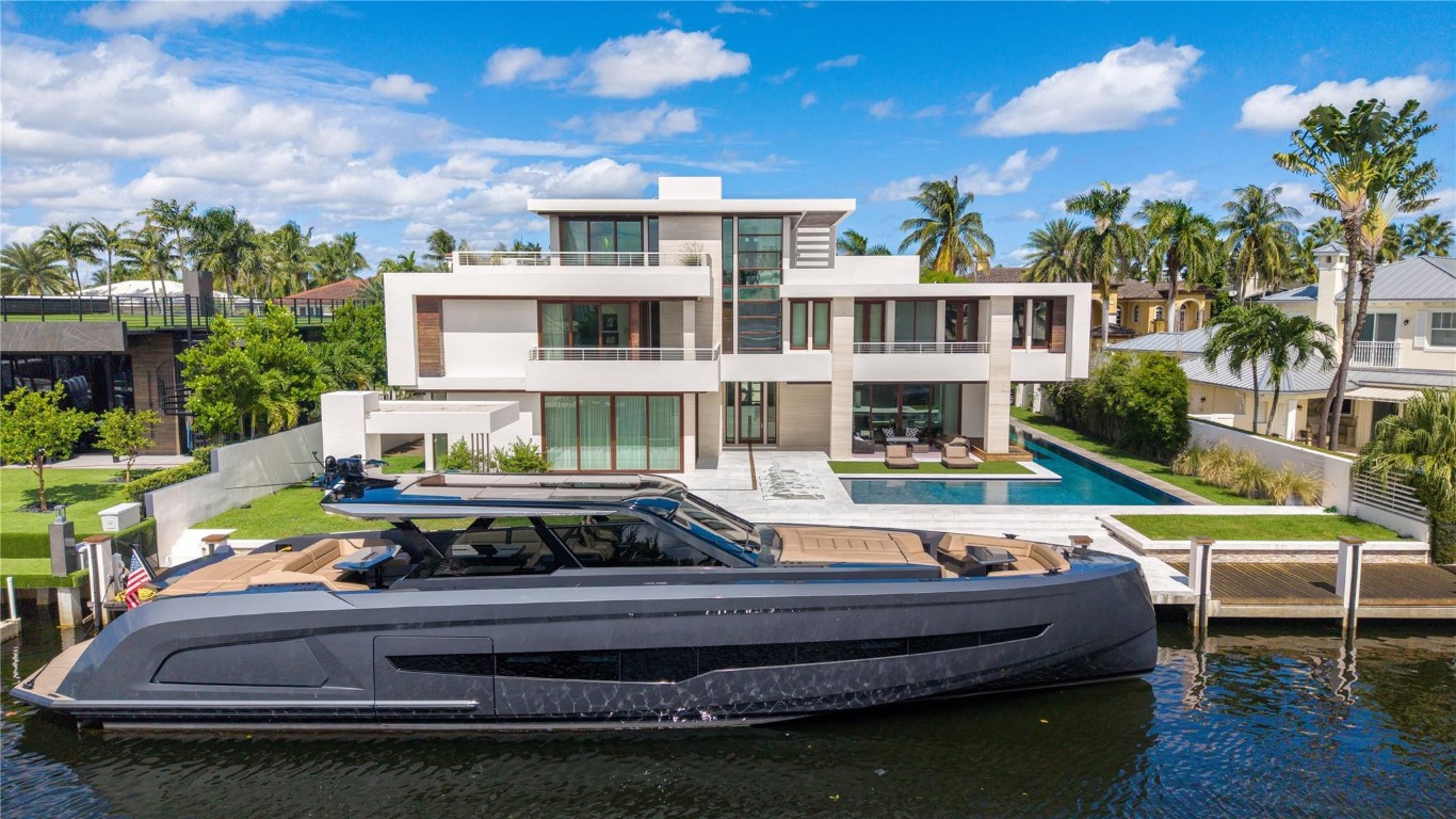 Welcome to 10 Pelican Drive—a super-custom tri-level organic modern estate blending clean lines with natural materials. 9300+sf Total Area built in 2014 with a major exterior renovation completed in 2024. 110ft of ocean-access dockage on a 130' deep lot. An orchid-lined courtyard with ipe yoga deck opens to interiors of polished limestone, ipe hardwood finished in a Brazilian baked varnish, and stone walls bathed in light. Sapele mahogany framed impact glass reveals an 80-ft heated lap pool and sun shelf. Exterior pergola for outdoor dining and BBQ, with an opportunity to design your own summer kitchen. A Miele-appointed gourmet kitchen with gas stove, generator, elevator, and third-floor entertainment level with panoramic Intracoastal and skyline views complete this rare offering.