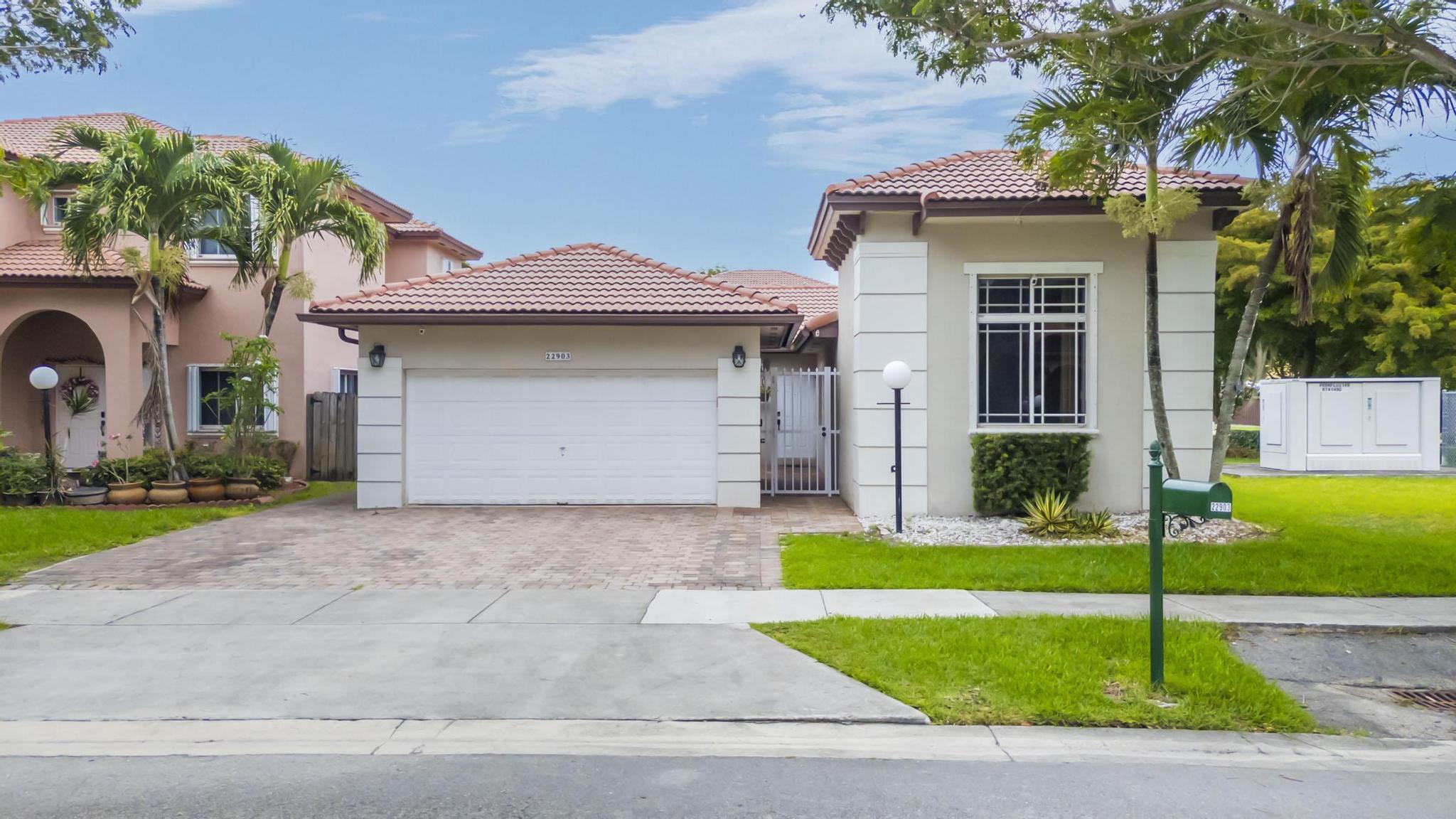 Beautifully maintained 4-bedroom, 2-bath home on a desirable corner lot in the lush Silver Palms community. This one-story residence features a charming private courtyard entrance with access to a detached 2-car garage, offering both privacy and curb appeal. The recently remodeled kitchen includes quartz countertops, wood cabinetry, and stainless-steel appliances. Elegant Italian tile flooring enhances the main living areas. Spacious backyard features a paver patio and room for a pool. Paver driveway offers plenty of parking. Additional features include storm shutters, Ring security system with cameras, newer AC (2019), and recently replaced water heater. Low HOA fees and move-in-ready condition make this home a must-see opportunity in a highly sought-after Miami neighborhood!