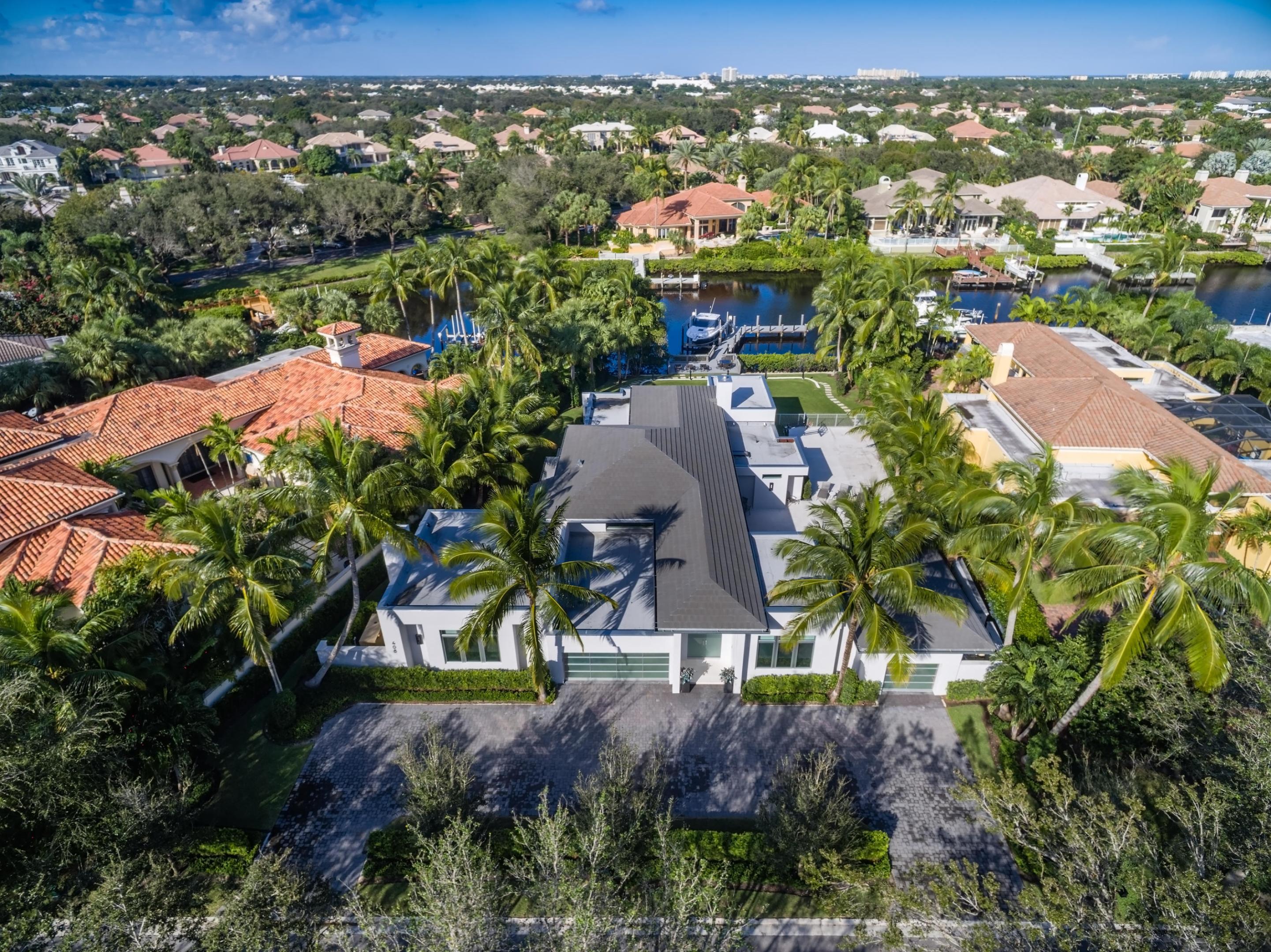 This home was meticulously rehabilitated in 2013, improved and expanded from the ground up, with the interior being completely reconfigured in order to create the open and inviting living and entertaining space that it has become. 5 bedroom, 5 1/2 bath home with separate 2 bedroom guest wing with private terrace in the main house and a one bedroom free standing guest house. Limestone floors throughout, ceiling detailing creates perfect room proportion, light and bright with transom windows. Impact windows and doors, whole house generator, Lutron lighting, indoor/outdoor music system. Island kitchen with breakfast bar, 6 burner Wolf range (double oven), Sub zero fridge and separate freezer, Miele dishwasher, pendant lights, glass tile backsplash, custom wood soft close cabinets. (more...) Night lighted garages viewable thru glass garage doors. Enjoy the outdoors with heated pool and hot tub, fire pit, summer kitchen, rear yard that may be used as a soccer field, marble floored/lighted exterior basketball court, and private dock with sundeck for up to 60' boat. 

Required golf membership purchase conveys all the first class amenities of Admirals Cove including two spectacular clubhouses, 45 holes of golf, 5 restaurants, 58 slip marina with floating docks, Yacht Club, 10 har tru tennis courts, 8 pickleball courts, state of the art fitness and wellness center with Technogym machines, 21,000 sq ft brand new spa & salon, Covesters kids club and Platinum service.