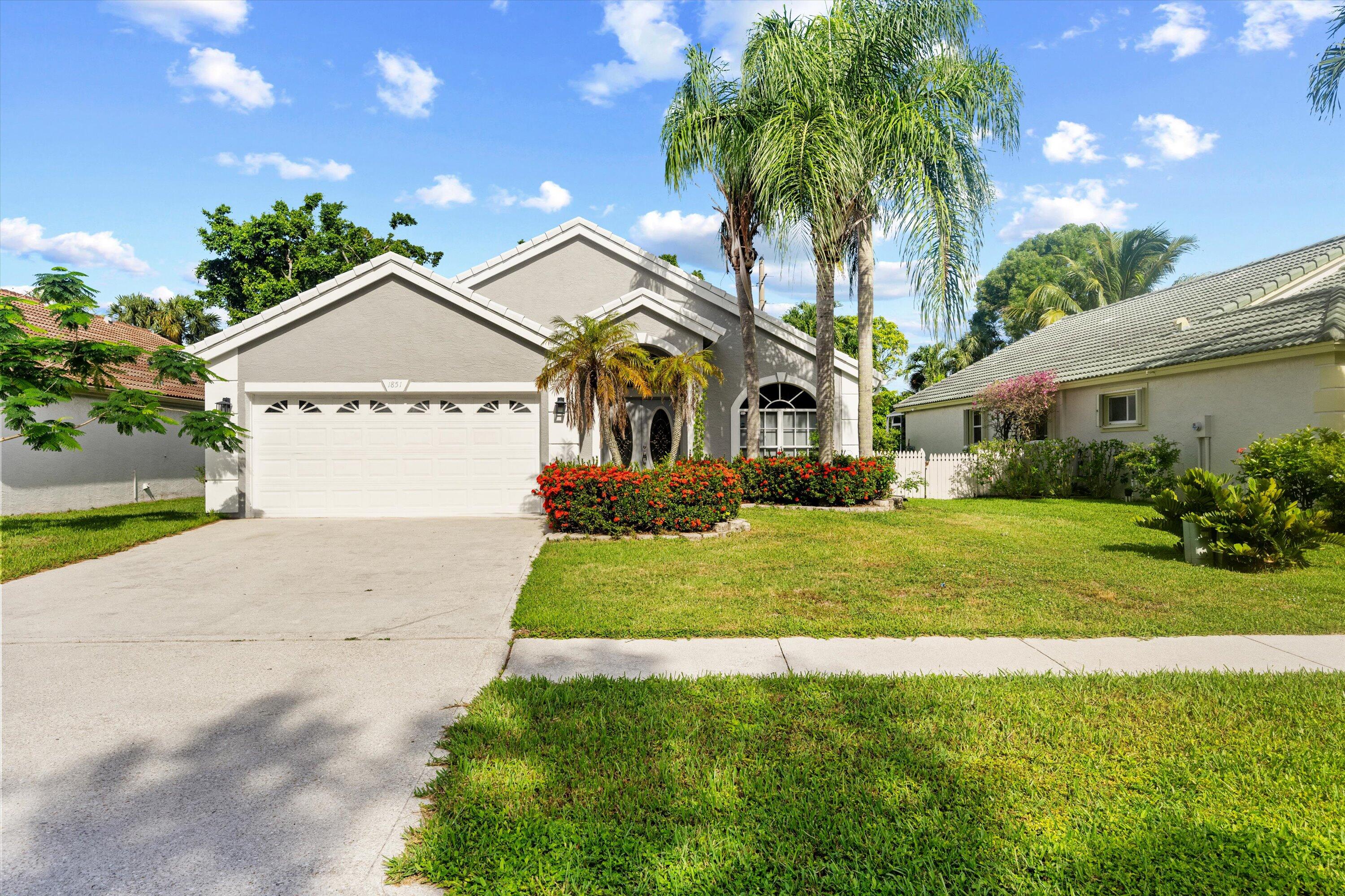 Welcome home to this beautifully updated 3-bedroom, 2-bathroom residence offering comfort, style, and complete convenience on one spacious level. Featuring no carpet throughout, this bright home boasts soaring vaulted ceilings, a split-bedroom layout, and a show-stopping stone fireplace with a crown molding mantle. The oversized kitchen is a chef's dream, fully equipped with a large cook island, built-in cabinetry, stainless steel appliances, and expansive granite countertops. Retreat to the private primary suite featuring dual walk-in closets and a luxurious en suite bathroom complete with a marble jacuzzi tub, separate shower, dual sinks, and a private water closet. Situated in the highly desirable gated community of Wellington's Edge, you are just minutes from top-rated schools,  world-class dining, premier shopping, legendary polo clubs, and equestrian venues. Excellent commuter location directly across from the Mall at Wellington Green, with quick access to Forest Hill Blvd, State Road 7/441, the Turnpike, and I-95. Community amenities include a clubhouse, sparkling pool, tennis courts, playground, and scenic walking trails. Schedule your showing today!