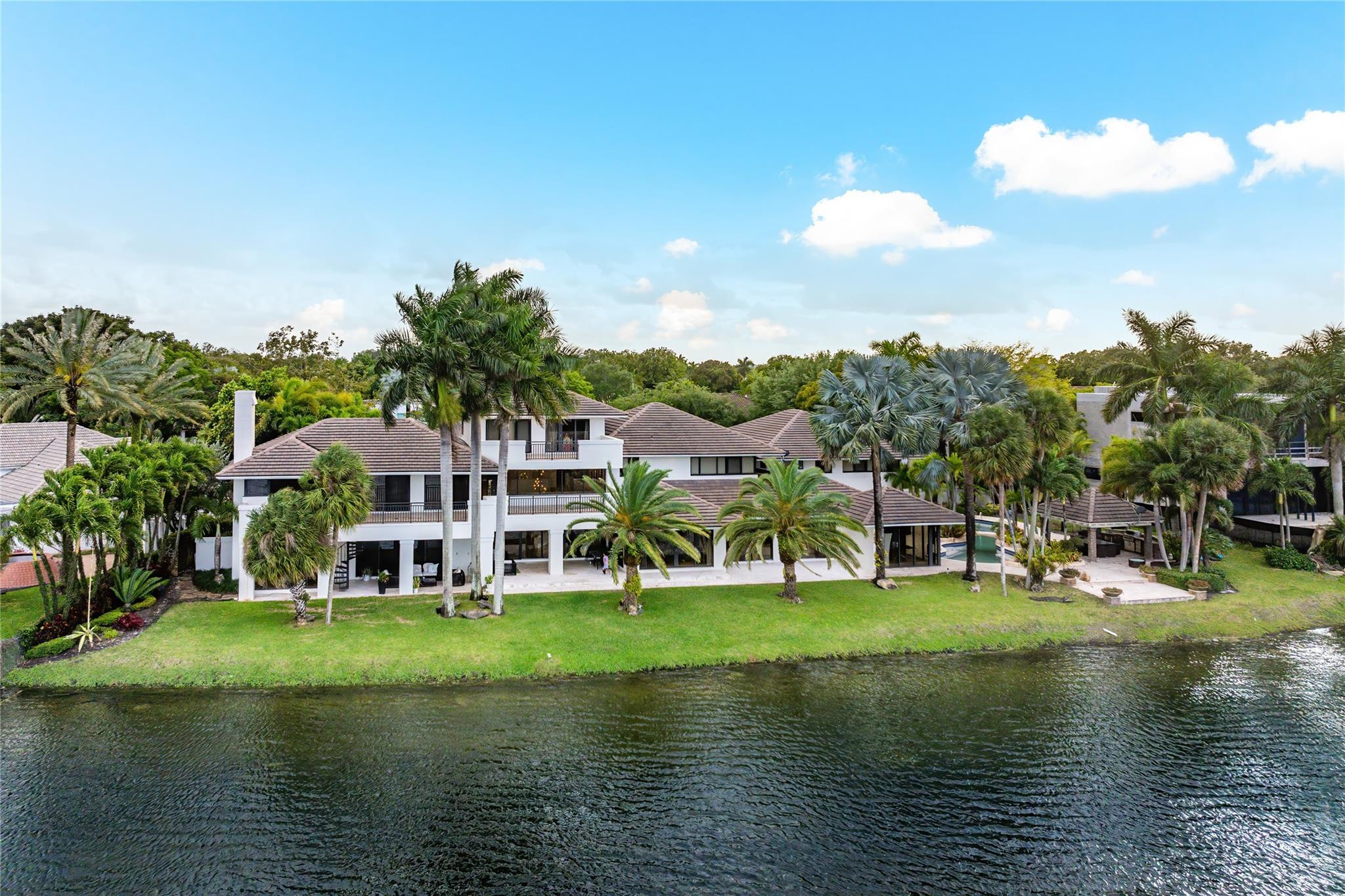 Largest home in the entire city of Doral. Spectacular 3 story waterfront mansion in Doral Estates! This 11,656 sq ft compound sits on a double lot with 232 ft of water frontage backing up to Trump National Golf Course, making it the best location in the neighborhood! Boasting 9 bedrooms, 10.5 bathrooms of pure elegance. This stunning estate is a dream for the lovers of everything space and luxury. Enjoy breathtaking lakefront and golf course views from almost every room in this home. All the spaces both impress and welcome throughout, with marble floors, open areas, and ultra-sleek finishes. Notable features include a beautiful koi pond at the entryway, resort style pool, outdoor kitchen pavilion area, a movie theater, and so much more .Memberships to the 5 star golf course & resort are available. Excellent location in a top rated school zone and 7 miles from Miami International Airport