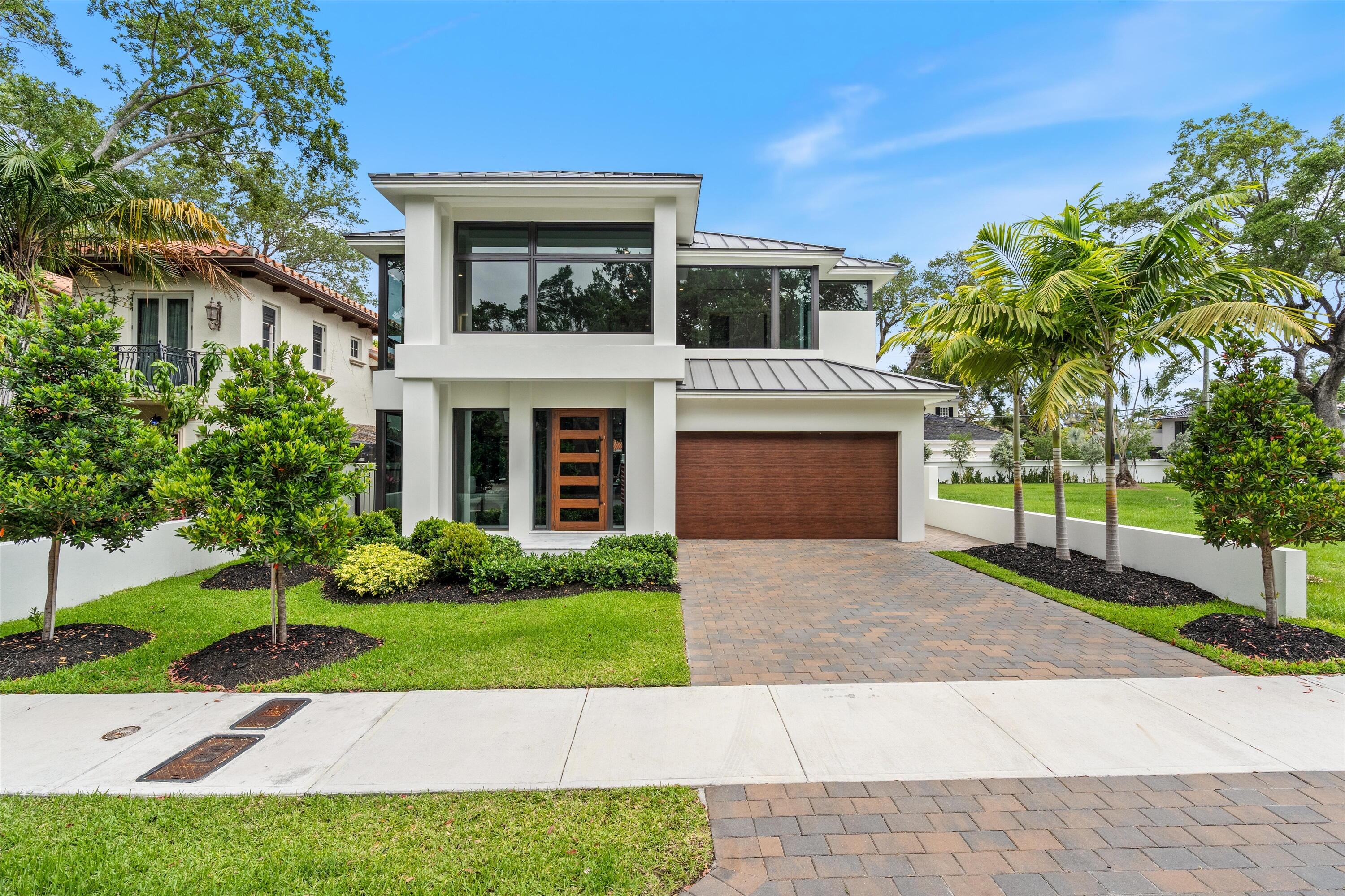 Built and ready to move in!!   Modern Transitional Masterpiece in the Heart of Colee Hammock. This thoughtfully designed home is complete and boasts oversized windows that flood the space with natural light, showcasing the lush, Old Florida vegetation and majestic oak trees. 5 bedrooms, 5.5 baths, an office/study, automatic generator, elevator, and a stunning wine cellar and bar, this home offers luxurious living at every turn. Enjoy the outdoors with a pool and a two-car garage, generator. Conveniently located near parks, shops, the beach, and the vibrant Las Olas Boulevard with its array of restaurants.