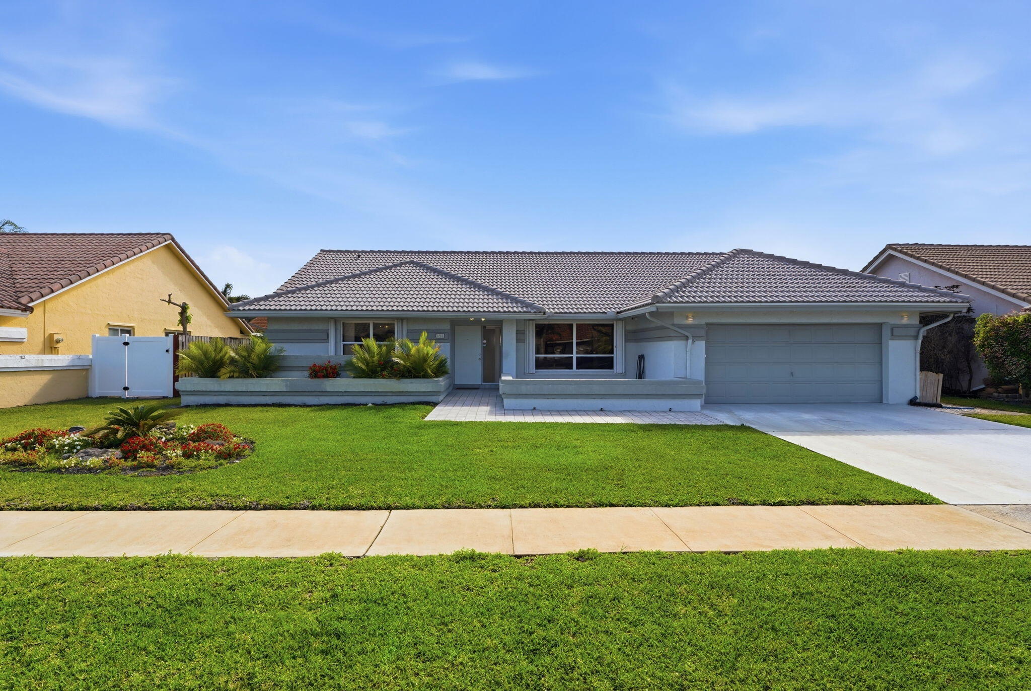 Step into this beautifully upgraded home in Sun Valley, offering the perfect mix of modern finishes, comfort, and true South Florida living. Inside you'll find bright 18'' white tile and Luxury Vinyl Plank flooring throughout, creating a clean, modern look. The layout features 3 spacious bedrooms, a large eat-in kitchen, and a separate dining area ideal for hosting. Both bathrooms include double vanities, making busy mornings easier Outside is your private oasis—an in-ground heated pool with a relaxing lanai, perfect for entertaining or unwinding year-round. The yard adds a tropical touch with fruit trees and even a raised pineapple bed. Major improvements include a whole-house generator with an underground propane tank. In 2021 the AC unit, pool pump, sprinkler pump, and tankless wh