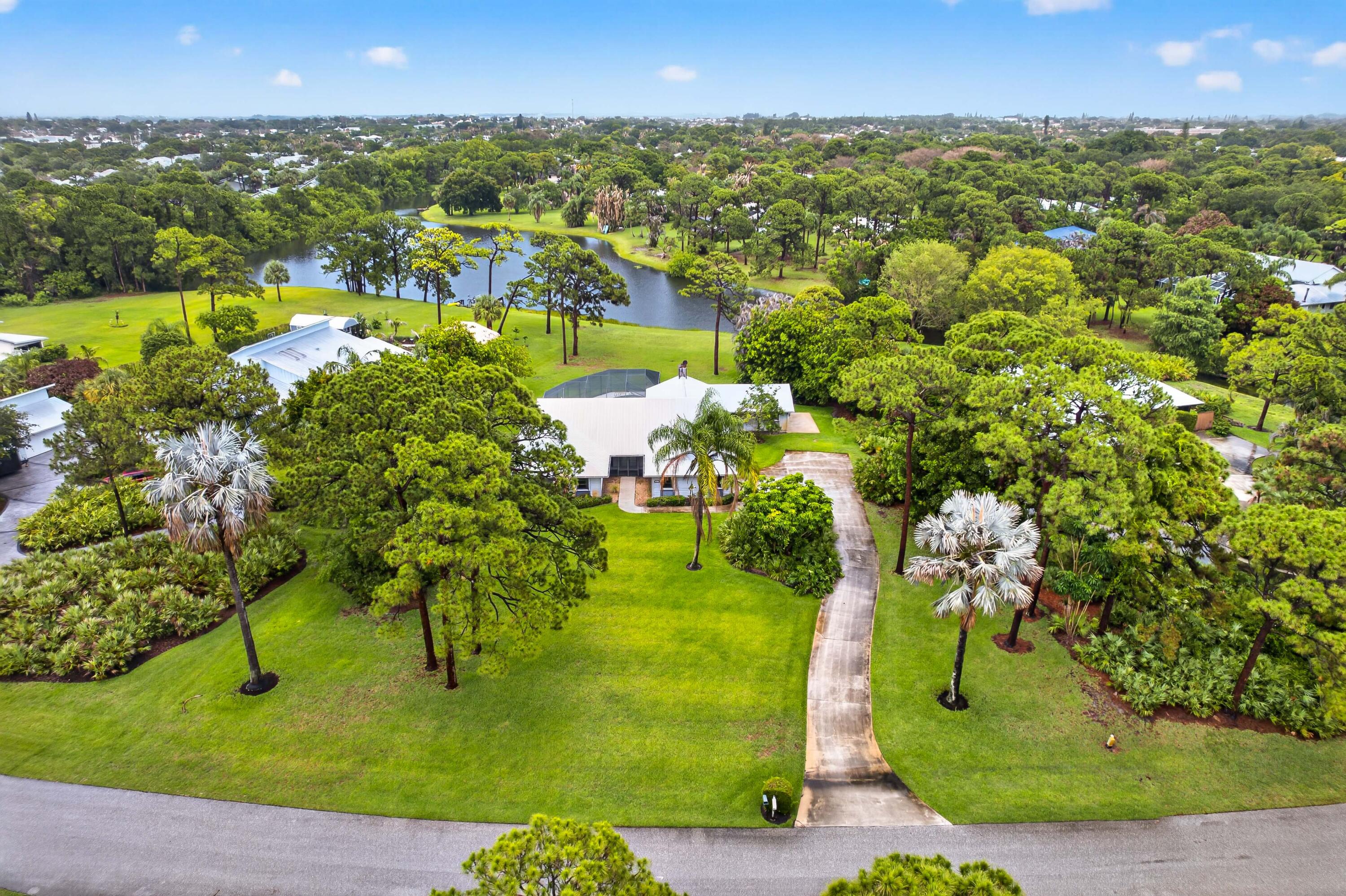 Opportunity awaits in Pinecrest Lakes! Situated on a picturesque 1-acre homesite with beautiful lake views and a dead end street.   Spacious 4-bedroom, 2.5-bath home with a 2-car garage and large screened in pool offers exceptional potential for buyers looking to create their dream home. Featuring a generously sized floor plan, the home centers around an open kitchen and family room with a cozy wood-burning fireplace. A large 442 s/f addition with its own private entrance provides flexibility for an office, guest suite, or multi-generational living. This property offers an incredible opportunity to add value and customize the home to your personal style. With its expansive square footage, desirable layout, and premium lakefront setting, this can be a truly outstanding residence.   Bordering the Savannas Preserve State Park, this is a rare chance to invest in a premier neighborhood and reap the rewards of renovation.