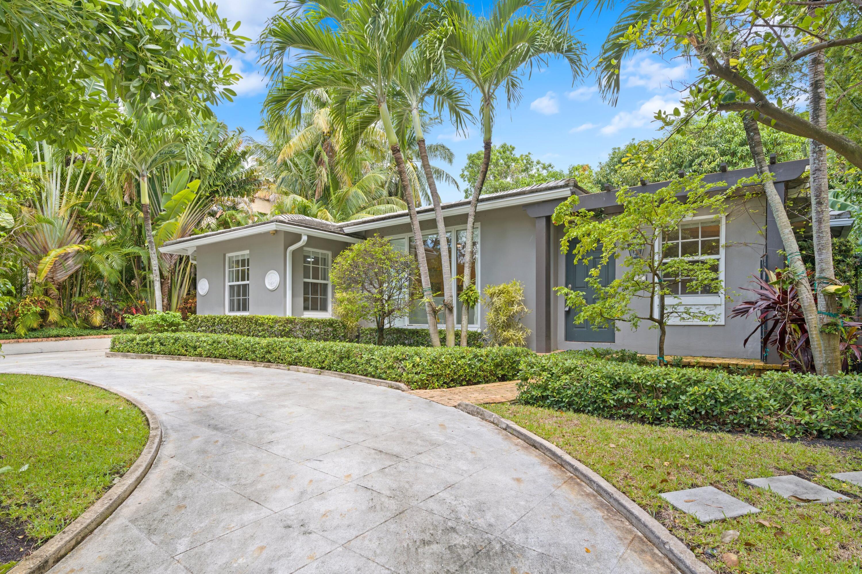 Charming Bermuda style home on the coveted 'Hill Block' of Historic Flamingo Park! This 3BR/3BTH CBS residence sits on a large 8,750 SF lot. The main house features 2/2 with designer finishes, gleaming hardwood floors, and bright and airy interiors with hurricane impact windows. Entry foyer boasts beamed ceilings leading into the light filled living areas. Custom gourmet kitchen with onyx backsplash, granite countertops, and gas range. Primary suite features ensuite bath and French doors with pool vistas. Attached guest suite is a 1/1 with ensuite bath and separate yard entrance. Backyard opens up with the Chicago Bricked outdoor living areas, saltwater & heated pool, all surrounded by mature & tropical landscaping. Close proximity to Palm Beach Island, CityPlace, Antique Row, and PBIA.