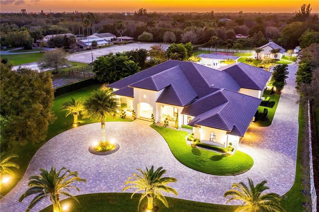 Sprawling gated contemporary modern estate and interior, this parcel is situated on nearly 3 acres. The interior features include 6 bedrooms, 6.5 baths, an office, guest house, four-car garage, fireplace, wine cellar, full home automation through Crestron with led coloring lighting, gourmet oversize chef’s kitchen with top of the line appliance package, and a massive walk-in pantry. Master suite includes his and hers closets, his and her water closets, separate tub, and stand up shower. All bedrooms have en suite baths. Backyard made for entertainment includes extensive covered lanai with a summer kitchen, cabana bath, a game room, resort-style pool and spa, basketball court, and batting cages. Detached 2,000 Sqft, 2 bed, 1 bath guest house, This estate is located on a prestigious street.