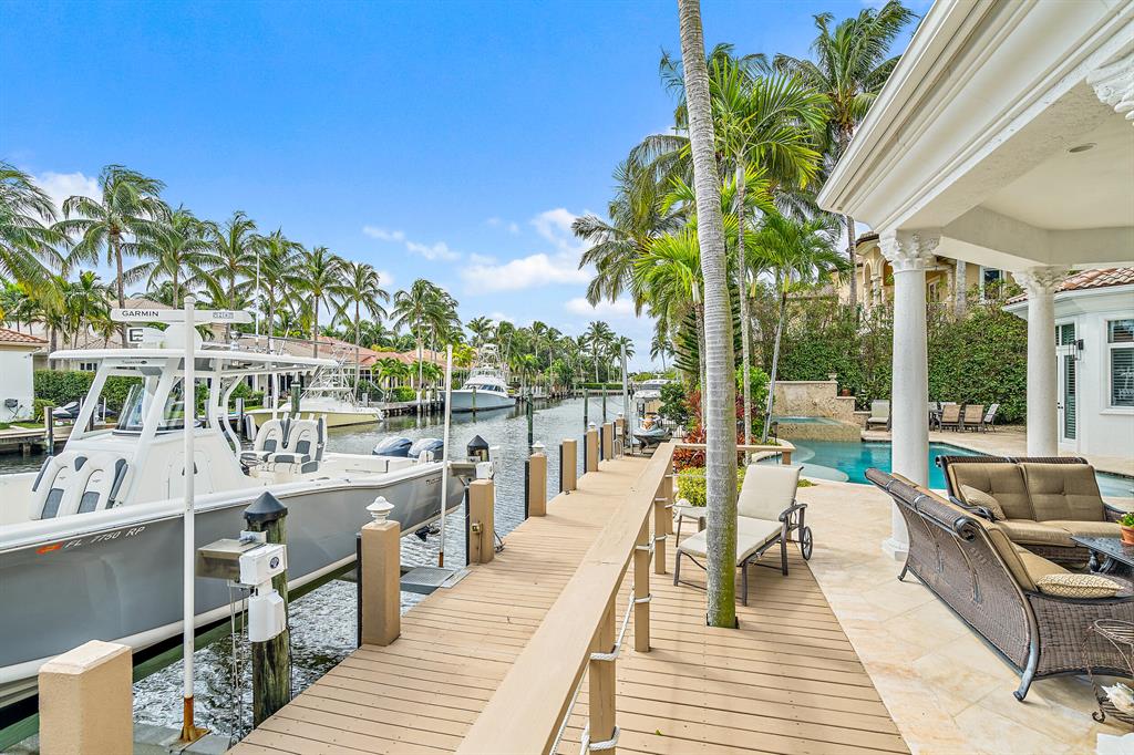 Welcome to Harbour Isles. Very private, gated Waterfront community with manned guardhouse & under 100 homes. 90' Canal frontage that can accommodate up to a 70ft yacht or multiple boats. Two lifts (18,000lb & Jet ski). The backyard features a custom pool & an oversized hot tub with waterfall & fountains that can comfortably seat 12 people. Summer Kitchen with grill, Refrigerator & separate ice maker. outdoor shower & cabana bath. Whole house 22 Kw Generator, full Impact glass. Newly painted exterior & recently painted Interior. Upgrades inside include but not limited to 200+ bottle wine closet, completely upgraded kitchen with top-of-the-line appliances featuring Miele coffee maker & system. Saturnia marble & wood floors throughout. Wired for both interior & exterior speakers. (See supp).. Upstairs Loft with storage closet/ bonus room. Paradise has been found.