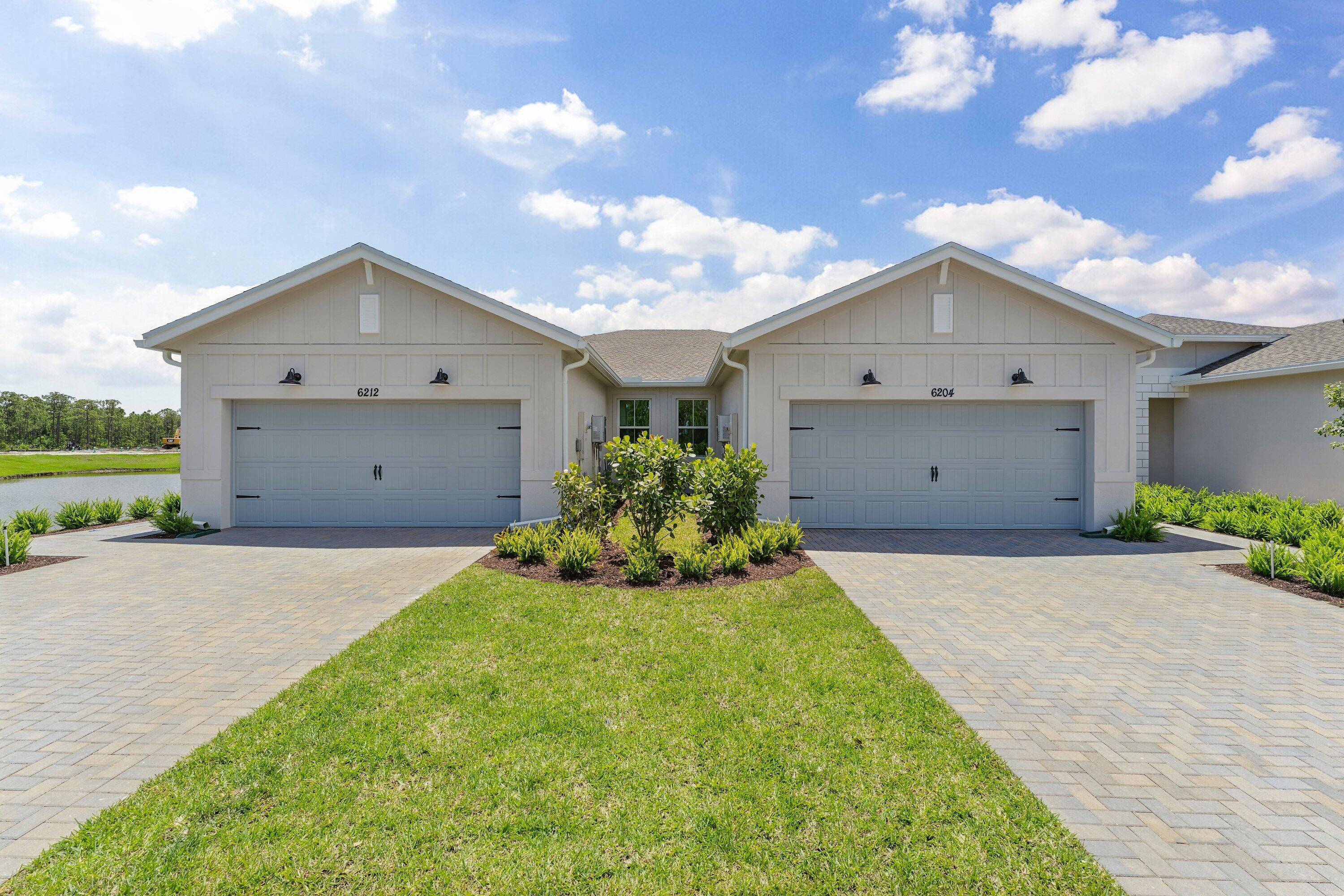 Welcome to the Spring Lake IV home plan from the Villa Collection at Four Seasons at Wylder, an exceptional 55+ active adult community in Port St. Lucie, Florida. This desirable homesite offers peaceful preserve views, providing a serene and private backdrop. The stylish villa showcases a designer-curated farmhouse aesthetic with wood-look tile throughout and a spacious island overlooking the open dining and great room, creating an ideal setting for both everyday living and entertaining. Rustic-inspired finishes include warm Winstead Birch cabinetry beautifully paired with Calacatta Abbezzo quartz countertops. Architectural ceiling details and abundant natural light enhance the home's modern elegance. The thoughtfully designed layout also includes a home office with a barn door just off the foyer, along with an open great room and dining area perfect for relaxed Florida living.  Immerse yourself in a resort-at-home lifestyle with access to a wealth of amenities and activities.