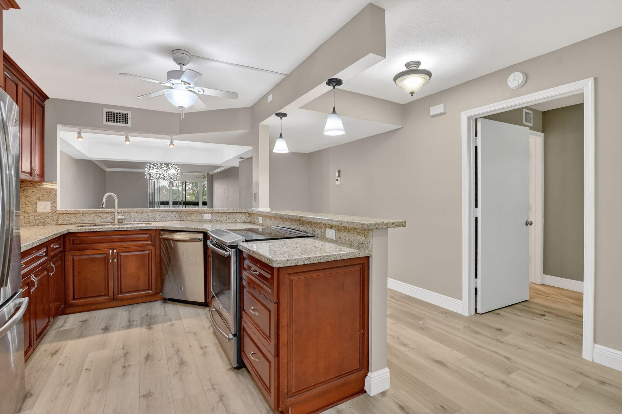 Rarely available corner unit in sought-after Boca Barwood, a vibrant 55+ community in West Boca Raton. This spacious 1,400 sq ft, 2-bedroom/2-bath home features en-suite baths in both bedrooms and windows in every room. New luxury vinyl flooring throughout, remodeled open kitchen, walk-in tub in the master, new guest shower, and an extra closet in the guest bedroom. Hurricane windows plus pull-down shutters on the back patio provide peace of mind. The building has completed roof, painting, elevator, SRS, and engineering report with stable HOA fees for 3+ years. Community features a heated pool, sauna, and active women's club. Minutes to shops, dining, West Boca Medical Center, Sawgrass Expressway & Turnpike. Virtually Staged.