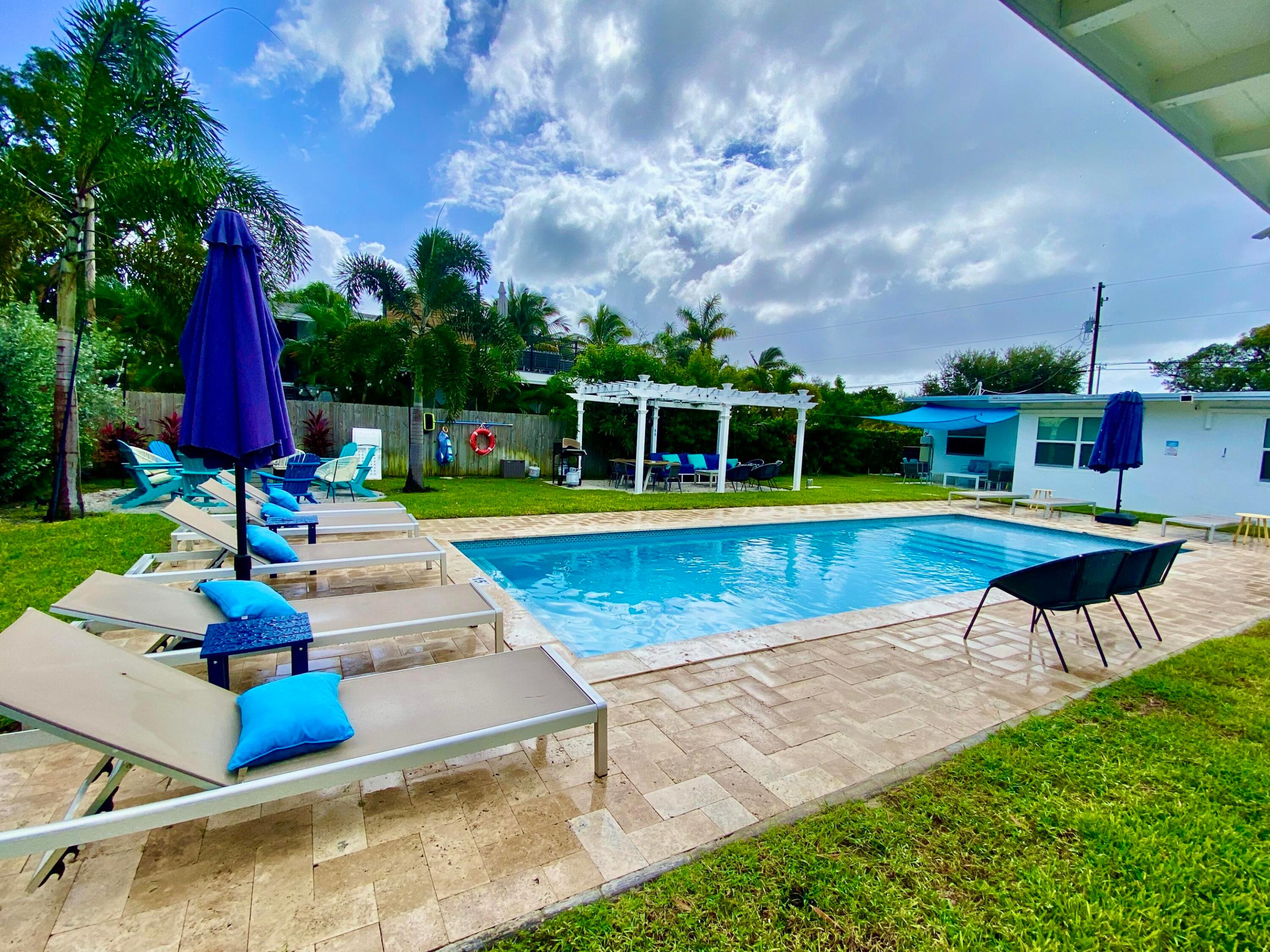 Do not miss this opportunity to own this 4- unit income producing vacation rental in Osceola Park, 3 blocks from Johhny Brown's. A mid-century modern, remodeled, turn-key, high demand rental close to everything Delray Beach has to offer - 3-yr-old heated pool, beautifully landscaped huge yard complete with oversized pergola, outdoor dining, grills, travertine pavers, corn-hole, fire-pit, lounge spaces with umbrellas. Each 2bed/1ba unit has hurricane impact windows and doors, 2022 AC mini splits, is plumbed for individual outdoor showers, furnished, in-unit laundry, tankless H20 heater, patio space, 1 parking spot p/unit, 4 guest spots, & golf cart charging station in lot. All units share the huge breathtaking backyard for a resort-style vacation retreat. Excellent development. opportunity