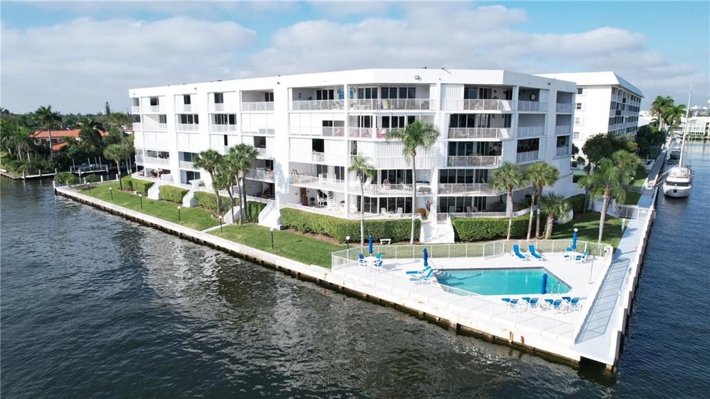 Waterfront living in corner residence w/ large covered terraces. Only 31 residences. Covered secured garage, pool directly on Intracoastal, storage room, fire place, wet bar, semi private elevator, new roof recently installed on building, guest parking. Located in desirable Coral Ridge.