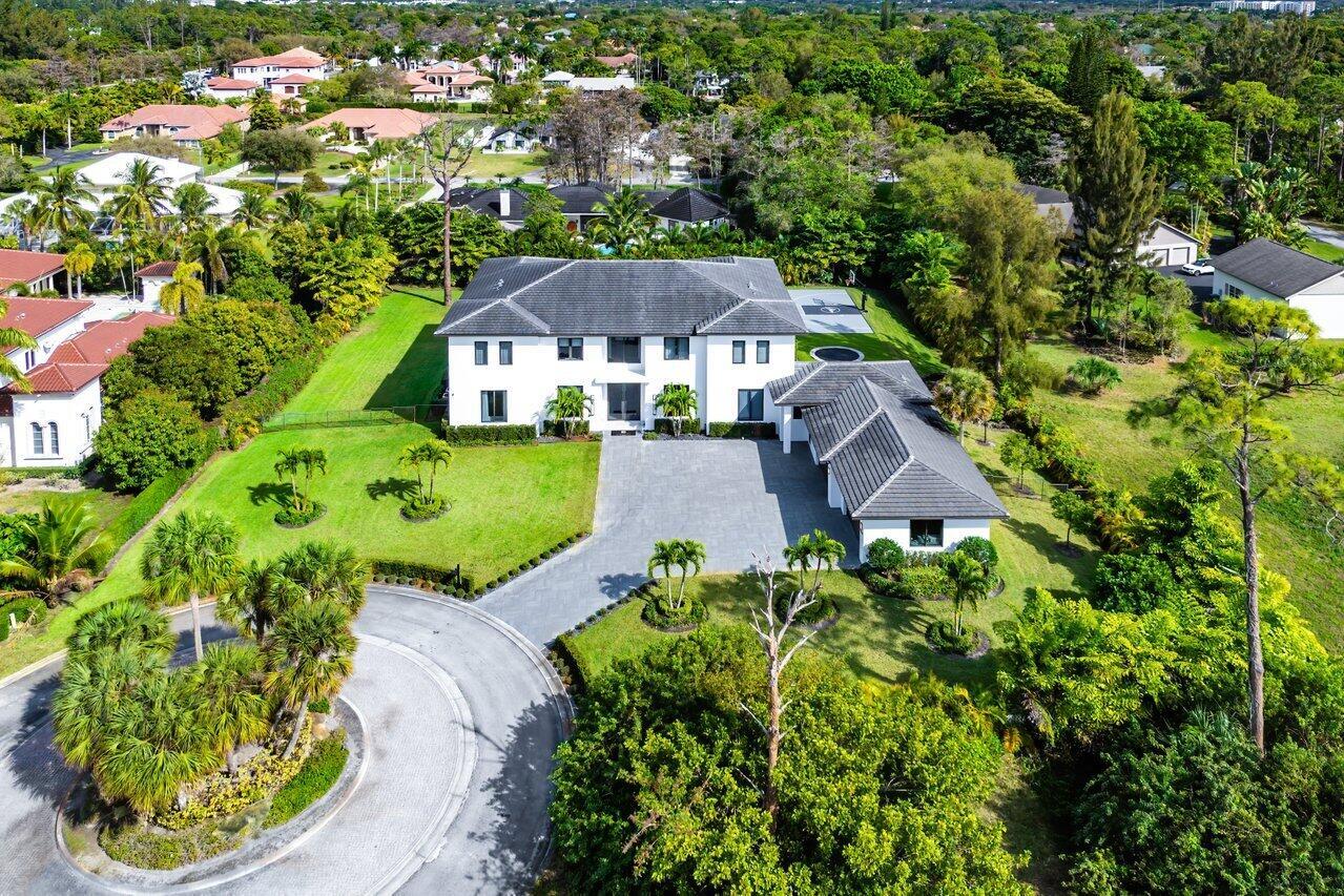 Nestled in the exclusively privately gated estate section of Parkland, this extraordinary 8,000 sq. ft. residence is a true masterpiece of design and luxury living. Located in a cul-de-sac neighborhood with only six neighboring estates, this stunning home offers unparalleled privacy and sophistication on a lush, one-acre lot. Negotiable turn-key furniture package with a multiple six-figure designer furniture package from world-renowned Artefacto, ensuring a seamless move-in experience with the finest in modern luxury. With seven bedrooms, seven full bathrooms, and two half baths, this estate seamlessly blends opulence, comfort, and top-tier entertainment. From the moment you step through the grand entrance, you're greeted by soaring 24-foot ceilings in the formal living room setting the tone for the home's expansive open floor plan. Every detail has been thoughtfully curated with custom built-ins, exquisite finishes, and luxurious touches throughout, making this residence truly ready for immediate enjoyment. The gourmet kitchen is a chef's dream, featuring top-of-the-line Wolf and Miele appliances, custom cabinetry, and a large walk-in pantry, ensuring effortless meal prep and entertaining. A spacious breakfast area flows seamlessly into the open dining and living spaces, creating the perfect setting for intimate family gatherings or grand entertaining. This home is second to none when it comes to entertainment. Enjoy the state-of-the-art movie theater with a modern concession stand for the ultimate cinematic experience. The billiards room, complete with a custom bar, is ideal for both relaxation and socializing, while the fully equipped gym with a sauna offers a private retreat for fitness enthusiasts. Step outside into your personal resort-style oasis. The oversized pool, surrounded by lush landscaping, creates a serene escape. For those who love to stay active, the backyard also features a private half-court basketball court, a putting green, and an in-ground trampoline. Designed for ultimate convenience, this home boasts two primary suitesone on each floorperfect for guests or multi-generational living. Both suites offer spa-like bathrooms with high-end finishes, soaking tubs, and expansive walk-in closets. Technology and functionality are seamlessly integrated with whole-home automation, allowing you to control lighting, security, climate, and surround sound at your fingertips. A four-car garage with custom built-ins provides ample storage, ensuring every inch of space is maximized. A rare find in the coveted Parkland area, this estate delivers an unmatched combination of modern luxury, convenience, and entertainment. With top-tier custom furniture, art, and accessories from Artefacto included, this home is truly one of a kind and ready for you to move in and enjoy.