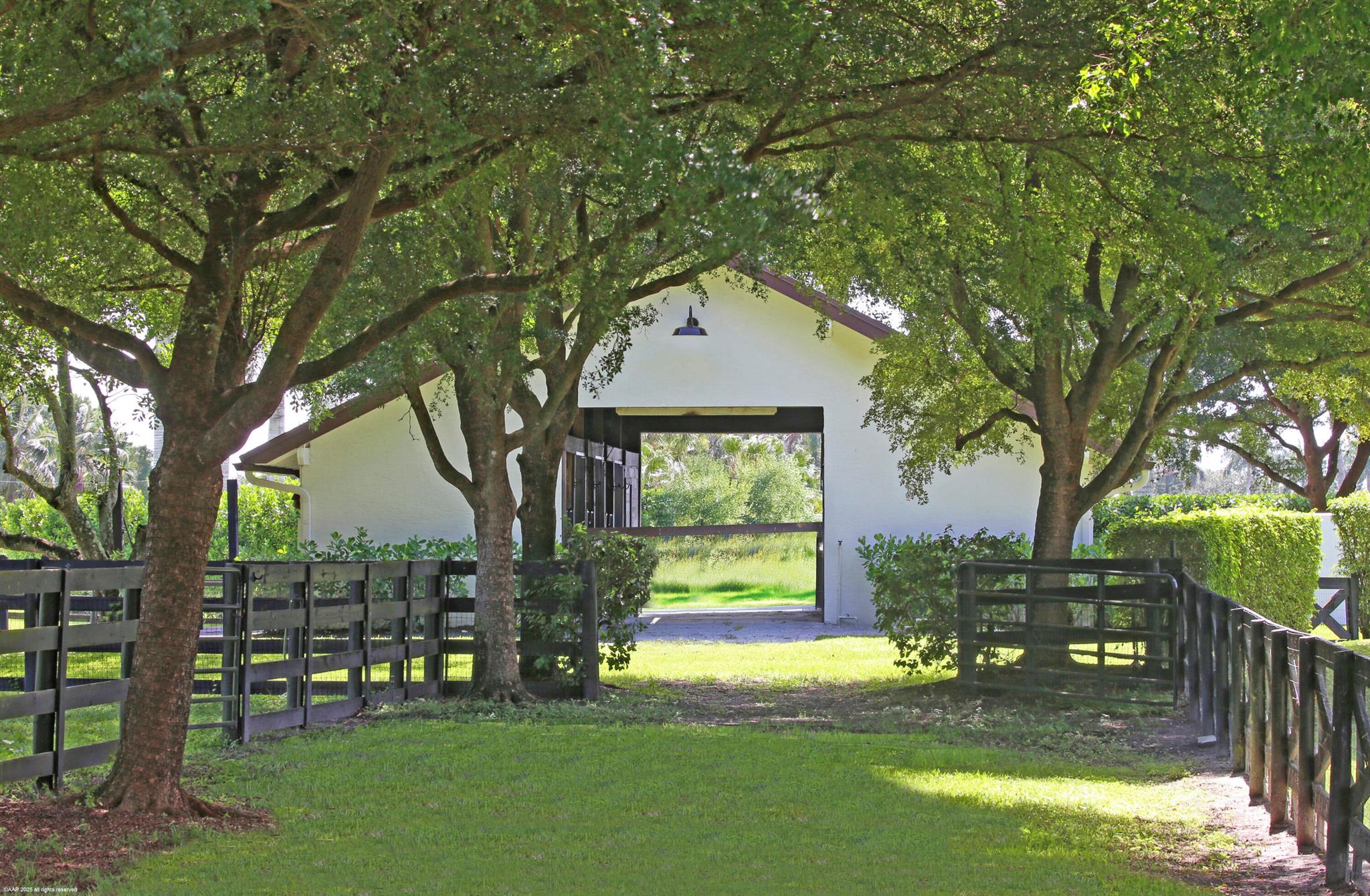 Located within the gates of Palm Beach Point, this is one of the most picturesque 5-acre lots. Perfectly tucked away at the end of a quiet cul-de-sac, this completely renovated 4-bedroom, 3-bathroom home with office and 3-car garage by JDM Builders is a very charming and thoughtfully designed home that seamlessly balances lifestyle and equestrian living. Step outside to a generously screened patio overlooking a resort-style pool and spa. Towering palms and lush, mature landscaping create a private, tranquil atmosphere rarely found in Wellington. The equestrian amenities include a 5-stall CBS barn with tack and laundry rooms, 3 wash racks, a 130' x 200' riding arena, a grass field, and 6 oversized paddocks - framed by mature trees and natural landscaping, providing shade and and peacefulness that your horses will appreciate. The property feels exceptionally unique. Ideally located near the back gate and close to the new horse show grounds - you are just a short hack away from all the action whilst maintaining privacy in a truly serene setting.

DISCLAIMER: All information provided to you regarding this Property by listing agent and her associates has been obtained from third parties such as the Multiple Listing Service, public records and other sources. All Buyers should independently verify all information provided regarding this Property. The Seller, listing agent and broker make no representation as to the accuracy of this information. The Seller, Realtor and Listing broker make no representation as to the accuracy of this information.
