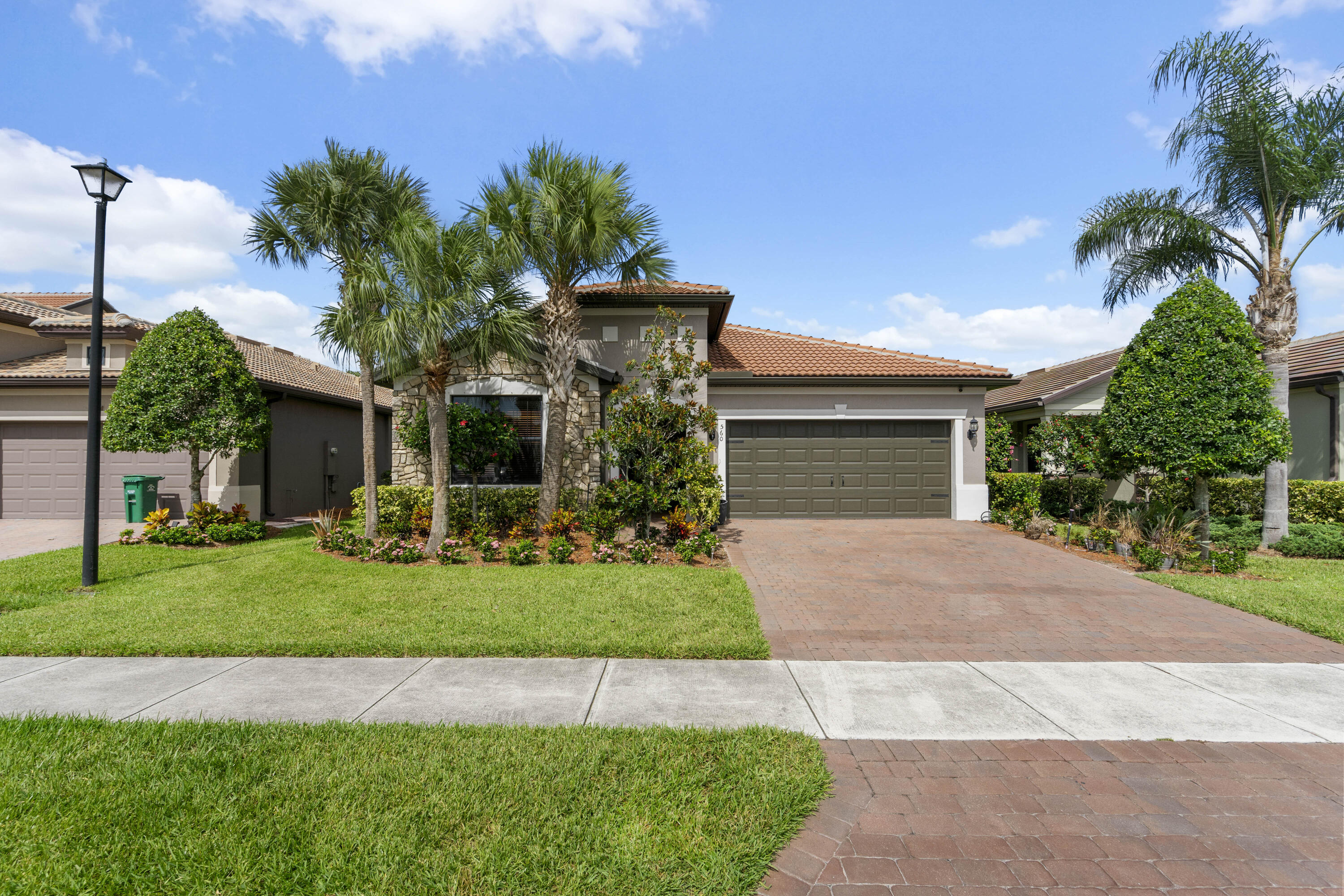 GORGEOUS 3BR+Flex/2BA/2CG home with numerous upgrades and a private fenced yard in Veranda Gardens! This home features tile flooring throughout, plantation shutters, glass entry front door. NEWER A/C, fresh exterior paint, pantry with custom shelving, screened & partially covered patio, additional flex space/office nook and more! The spacious kitchen features white cabinets, a large center island, SS appliances including gas range, pendant lighting, tiled backsplash, granite counters and large pantry. Open floorplan ideal for modern living. Master suite has views of the back yard as well as an ensuite with dual sinks, tiled shower and walk-in closet. Two guest bedrooms have access to a hall bathroom. The fully fenced and private back yard is a great spot for your furry friends!  VERANDA GARDENS is a gated community nestled minutes from Palm City & Stuart with plentiful amenities including a clubhouse, playground, fitness center, multiple pools, dog park, pickleball, tennis, fire pit, outdoor bar/dining area, grilling areas & more. Conveniently located with access to interstates, beaches, shopping, restaurants and schools.  THIS HOME IS THE COMPLETE PACKAGE! Call today to view this wonderful property!