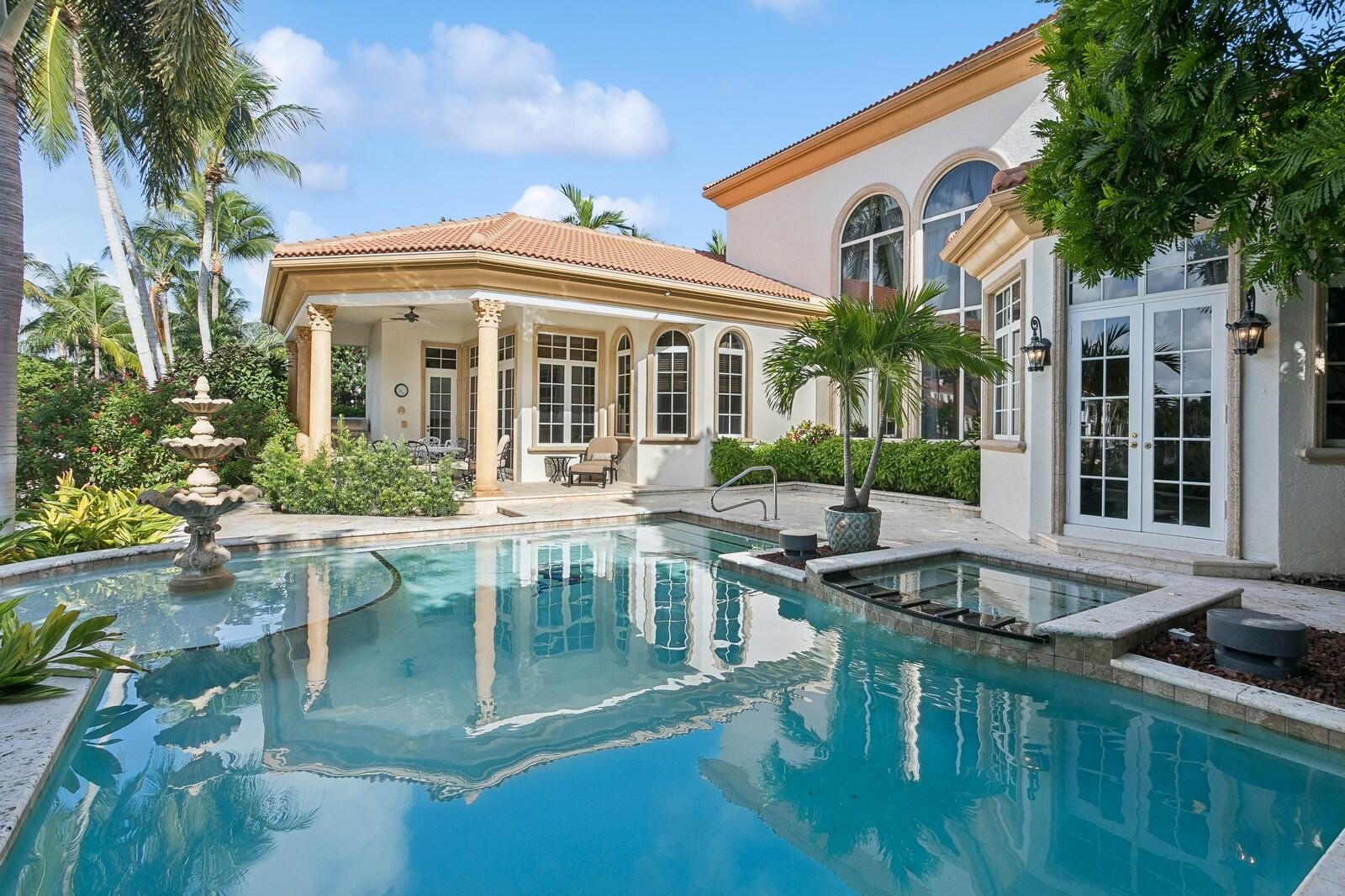 This exquisite waterfront property in a prestigious gated community in North Palm Beach offers luxury living at its finest. Featuring a private dock with accommodations for a 70 ft boat, complete with water & electricity, this  home is perfectly suited for boating enthusiasts.
The residence includes 5 spacious bedrooms plus a large office with built-in features, & 5 elegant bathrooms. The owner's suite is conveniently located on the first floor & boasts walk-in closets & his-and-her bathrooms. The gourmet kitchen is a chef's dream, equipped with a large island, dual sinks, natural gas for cooking, & top-of-the-line appliances. Additional highlights of the property include a stunning pool, spa, swim deck, complemented by a summer kitchen & ample space for sunbathing. The home is fortified with impact glass for added security and features a 3-car garage. Inside, marble floors with intricate inlays add a touch of sophistication, while a bar area with a refrigerator, ice maker, and sink provides a perfect space for entertaining. The elegant wood stair railing leads to a large loft and two additional bedrooms upstairs, completing this luxurious and functional estate. This home is close to shopping, dining and 15 minutes to the beach.