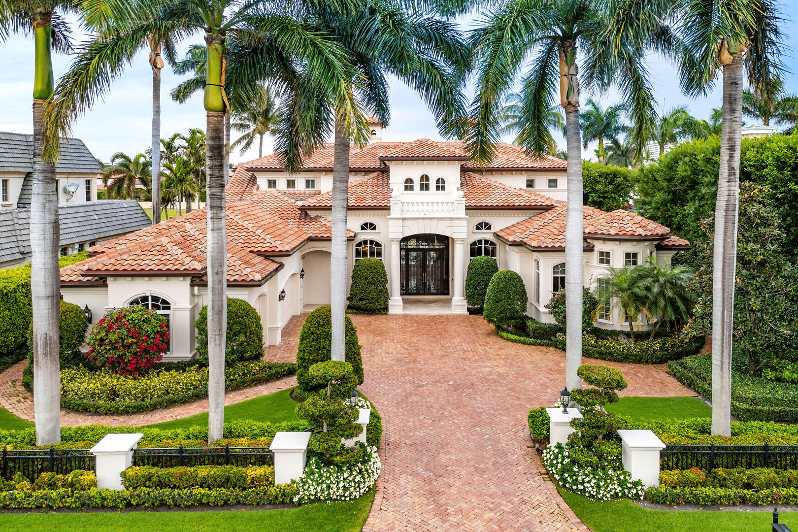 This exceptional residence boasts a coveted eastern exposure, bathing the interiors in morning sunlight while offering stunning views of the 15th fairway. Designed for both grand entertaining and private relaxation, the outdoor sanctuary features a custom-heated pool with a raised spa, a marble-clad deck, and a covered patio complete with a built-in grill for effortless al fresco dining wrapped in lush tropical landscaping. Inside, soaring ceilings with floor-to-ceiling windows create a dramatic ambiance in the formal living room, anchored by a striking statement gas fireplace. The formal dining room is complemented by a well-appointed butler's pantry and an expertly equipped wet bar, perfect for hosting with ease. A gourmet kitchen outfitted with a center island and premium appliances caters to culinary enthusiasts, while a richly appointed study with custom wood built-ins and trim offers a distinguished workspace.

The first-floor primary suite is a serene retreat featuring a spa-inspired bath, His & Her walk-in closets, and a private exercise room. Thoughtful luxury extends throughout with natural gas, a whole-house generator, and impact glass windows and doors, ensuring comfort and peace of mind.

EXCLUSIONS: DINING ROOM AND BREAKFAST ROOM CHANDELIERS. DRAPES IN FAMILY ROOM AND MASTER BEDROOM.