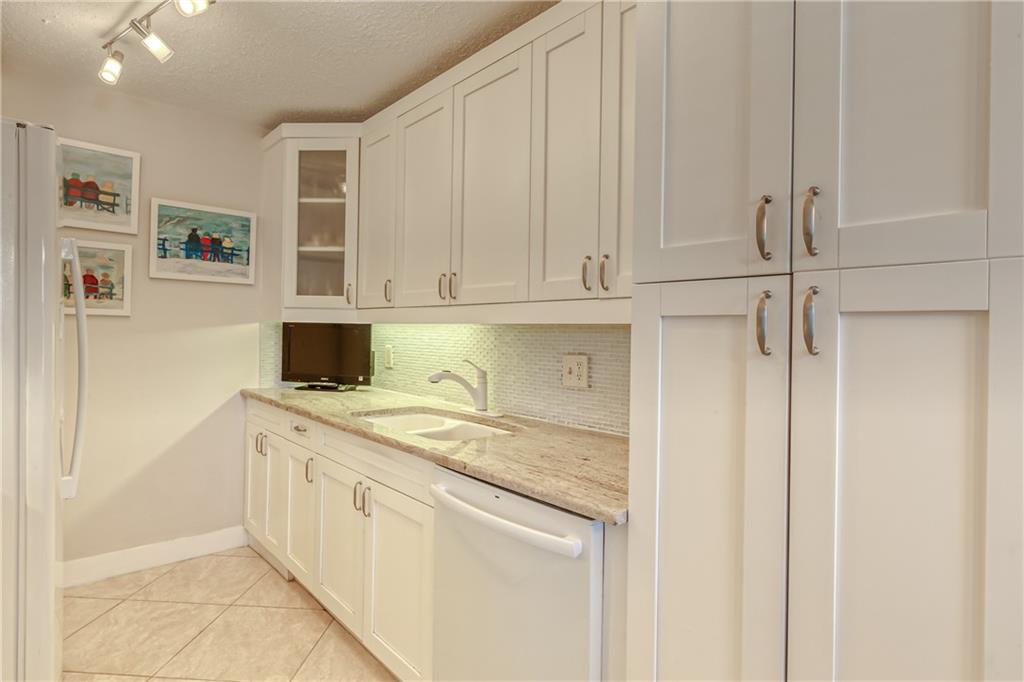 Beautiful 2 Bedroom 2 Full Bath Condo In Sought After Building Of Century Village. Property Conveniently Located On The First Floor. This Unit Has Been Partially Remodeled With an upgraded kitchen. New Kitchen Boasts wWhite and Bright Cabinetry and Granite Countertops. Newer A/C only 1 year old.  FURNITURE included in price.  Conveniently located next to shopping and restaurants.