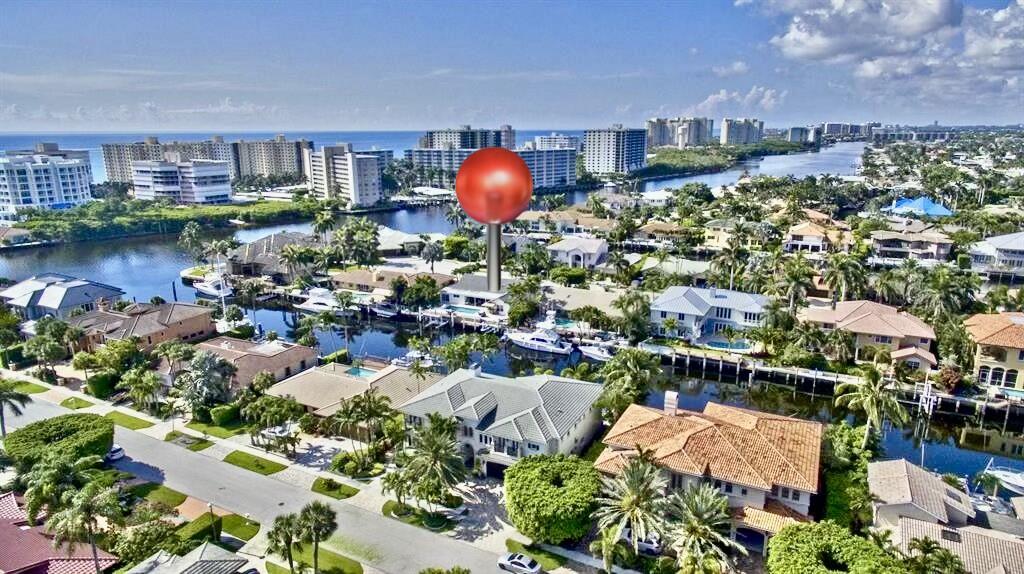 Waterfront living at its finest. This bright and open home, second from the point lot, offers 2,699 SF under air, 4 bedrooms, 3 baths, luxurious Italian oak-look porcelain tile flooring throughout, and direct Intracoastal access. Enjoy a designer chef's kitchen w/ Sub-Zero and GE Monogram appliances, custom built-ins, and a luxurious primary suite with pool and water views. Outside, your private oasis awaits with a heated pool and jacuzzi, expansive marble patio deck overlooking the water, 90-ft dock, 25,000 lbs boat lift, fish-cleaning station, covered outdoor kitchen w/ TV, all-new tropical landscaping, a turfed side yard, and a marble driveway with elegant turf inlays for added curb appeal. The home also features a fully integrated smart home system with ADT security, impact windows