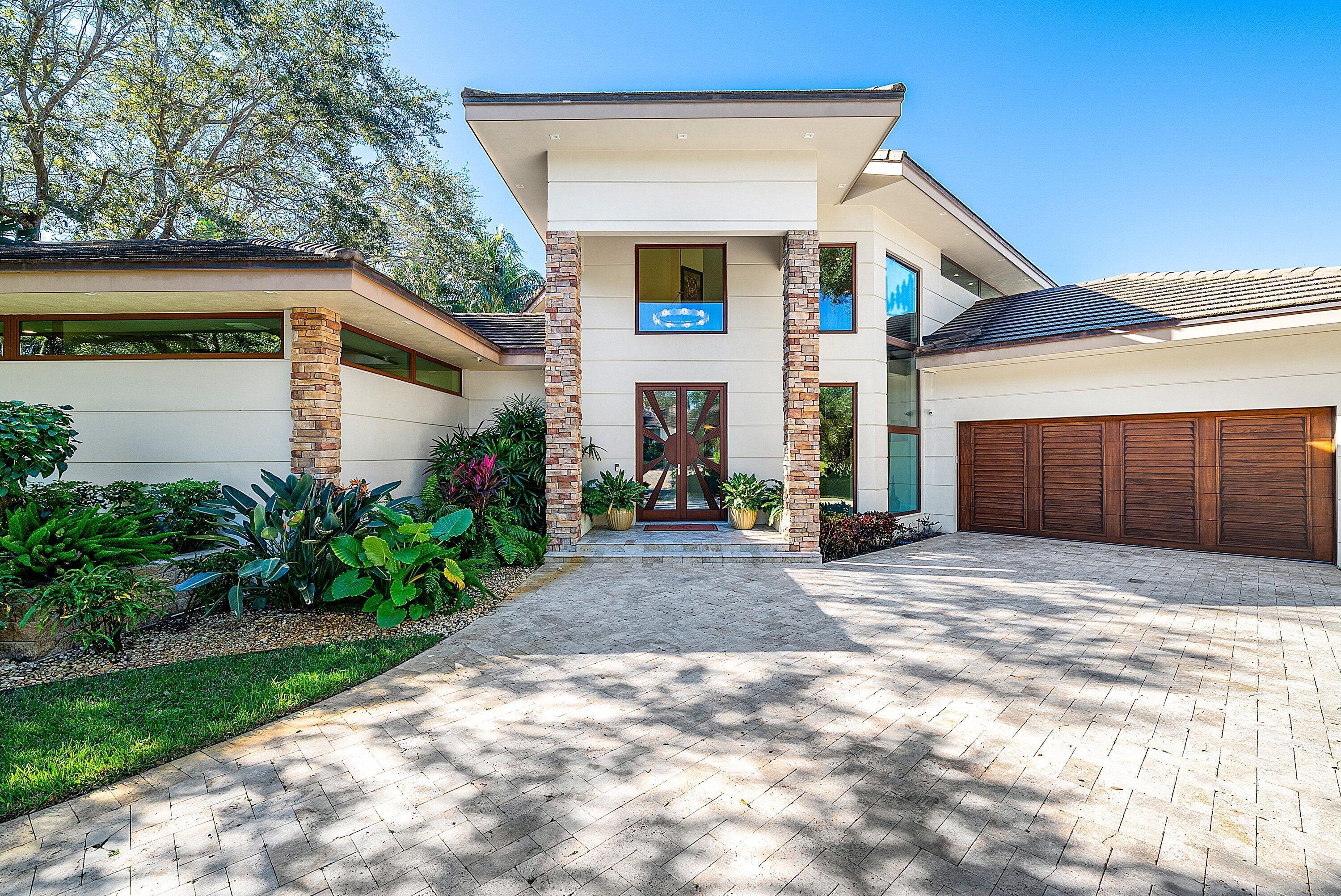 Exquisite Waterfront Estate in Prestigious River Ridge   Nestled within the exclusive enclave of River Ridge , this custom-built builder / owner 2012 waterfront residence offers an unparalleled blend of sophistication, comfort, and timeless craftsmanship. With captivating long views of the Loxahatchee River gracing nearly every room, this home is a serene sanctuary designed for refined living and effortless entertaining.  Meticulously reimagined in 2024-2025, the property features a state-of-the-art designer kitchen boasting dual islands, Sub-Zero and Thermador appliances, a 44-inch Galley sink, and bespoke designer lighting that perfectly complements the home's architectural elegance. The first-floor serves as a private retreat, complete with a custom fireplace, a built-in wall unit.  Homes Price includes full furnishings , 24 center console Boat and Jet ski!!