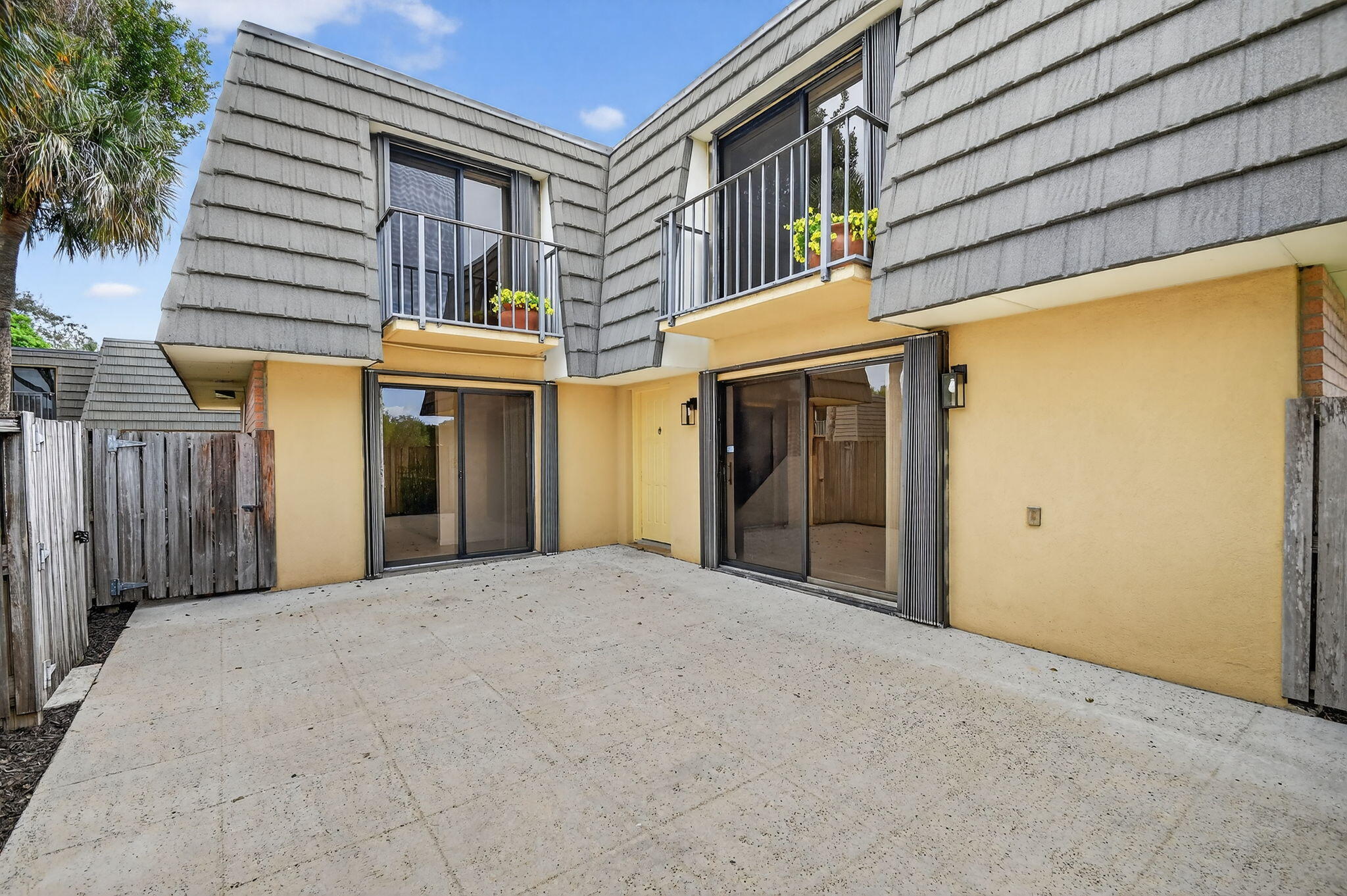 Motivated Seller!! Welcome home to this bright and well maintained 2 bedroom, 2 1/2  bath townhouse featuring fresh interior paint, neutral tile throughout the main living area, and brand new carpet on the stairs and in both bedrooms. Enjoy peaceful water views from both upstairs bedrooms. Enjoy the convenience of accordion hurricane shutters, a fenced and private patio - perfect for relaxing or entertaining. Community amenities include pool, basketball, tennis courts and more. Conveniently located near shopping, dining, I-95 and downtown West Palm Beach and schools.
