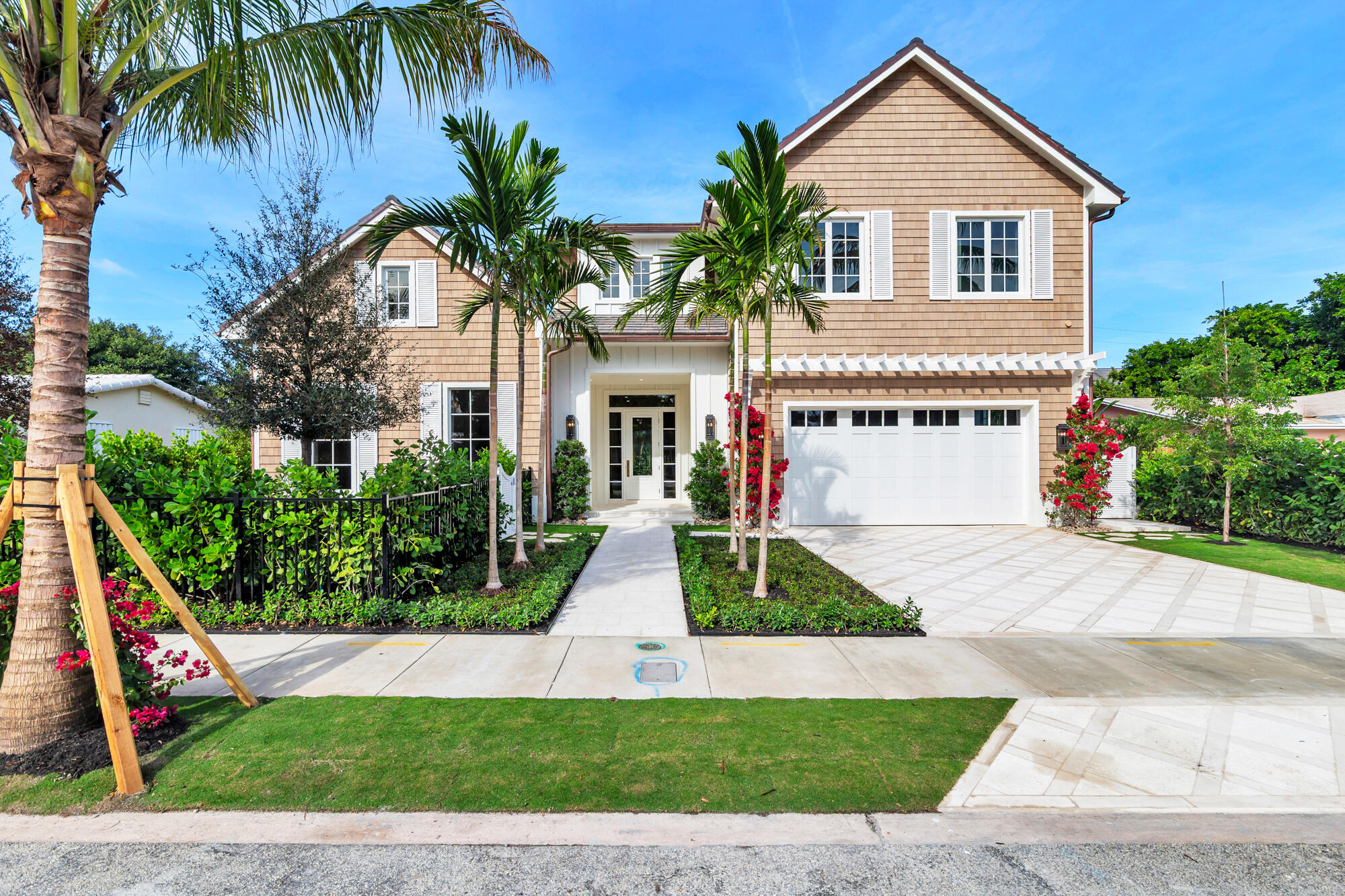 Situated yards away from Flagler Drive and the Intracoastal Waterway rests this stunning new construction home. Featuring 5 bedrooms, 5 full bathrooms and 2 powder rooms, this 5,660 total square foot home was built and designed with extreme attention to detail.  Walking in the home, your eyes immediately affix to the incredible millwork. Every inch of this home was designed for the most discerning buyer. The kitchen is a dream come true boasting marble countertops, custom made cabinets, Thermador appliances, a Lacanche Range and a butler's pantry with ample storage space. With a built-in back-lit bar and custom built in shelving, the open concept family/ living/ dining room is both cozy and luxurious.  Highlighting a first floor primary bedroom with cathedral ceilings, a massive walk-in shower/ tub wet room, an oversized dual walk-in closets, a private laundry room and a 7' x 26' private office/ loft. The primary bedroom and all its finishes were very obviously curated by a professional designer. The second floor offers a large loft area, laundry room and 4 bedrooms each with an en-suite bath.  Step into your own private Florida oasis. This resort-style backyard is anchored by a sparkling pool framed by lush, mature landscaping for total privacy. A spacious covered loggia offers the perfect place to relax or entertain. The cabana provides an outdoor kitchen and a dedicated pool bath for convenience. Designed for year-round enjoyment, this outdoor retreat blends comfort, beauty, and coastal living at its finest.   Close to Worth Avenue shopping, Five-Star restaurants, I-95, PBI Airport, Mar-a-Lago, fabulous white sand beaches and much more.