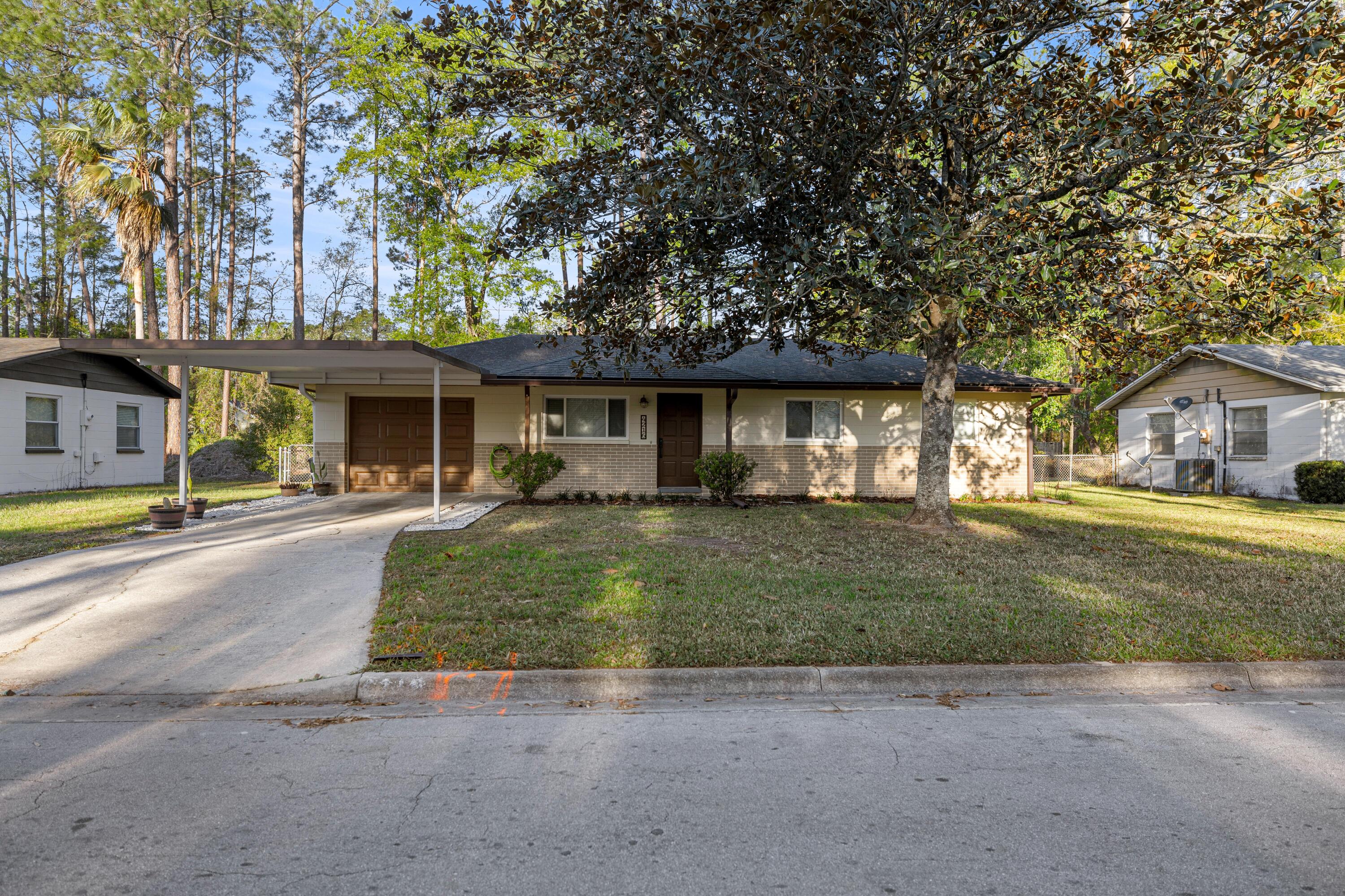 Beautifully renovated home in desirable northwest Gainesville... Nicely landscaped gated\fenced yard...Covered porch and patio ... 1 car garage with 1 car carport...Come see your new home!