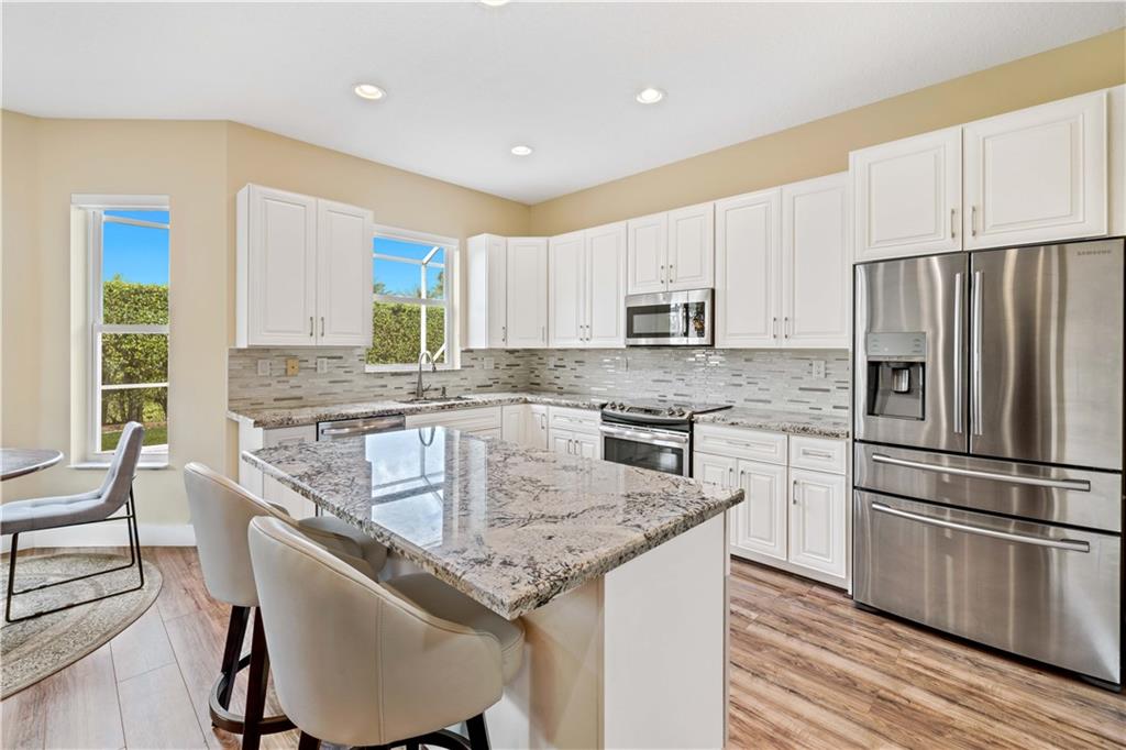Welcome Home! This gorgeous completely updated home located in the highly sought after gated community, Eagle Lakes, welcomes you as you enter into the foyer and hosts a seamless elegant flow between the living room, kitchen, family room, and dining area. Stunning gourmet kitchen with a large island, white soft-close cabinetry, and new SS appliances. Hurricane impact glass and doors throughout. Custom closets. Freshly painted inside and out. Beautiful pool that was just resurfaced. Recessed lighting throughout with dimmers. Garage is carpeted - perfect for a home office or gym! A/C was installed in 2016,  owner has the A/C serviced every 3 months! Roof, home, and sidewalks just power washed. Barrel tile roof. Owner keeps this home in pristine condition! All updates were done with permits.