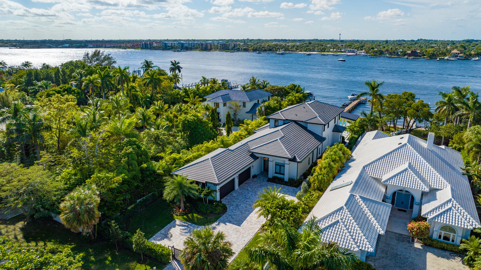 Built in 2022 and never lived in by its first owners, this designer appointed, furnished, direct-Intracoastal modern estate lives like brand-new construction. Offering an impressive sense of arrival, the front entry gates open to the brick-paved motor court set amidst lush tropical landscaping, and in the backyard, nothing is left wanting in this entertainers delight. Here, two loggias and a fully-equipped summer kitchen are adjacent to the sun-dappled, oversized salt-water infinity-edge pool dramatically inset with a spa, sun shelf, bar and sunken fire pit.  An arbor enhanced by a cascading waterfall provides another striking focal point, and attractive to water-sports enthusiasts with 75+/- feet on the intracoastal Waterway and direct ocean access with no fixed bridges. South Atlantic Drive, Lantana, Florida.  Hypoluxo Island preserves Old Florida tranquility on a scenic barrier island surrounded by the Intracoastal Waterway in the heart of South Florida's Gold Coast, midway between Palm Beach and Boca Raton.  Just across the bridge is the sugar-sand ocean beachfront of Manalapan, home to the Five-Diamond Eau Palm Beach Resort & Spa.
 
PROPERTY:

Offering an impressive sense of arrival, the front entry gates open to the brick-paved motor court set amidst lush tropical landscaping, and in the backyard, nothing is left wanting in this entertainers delight. Here, two loggias and a fully-equipped summer kitchen are adjacent to the sun-dappled, oversized salt-water infinity-edge pool dramatically inset with a spa, sun shelf, bar and sunken fire pit.  An arbor enhanced by a cascading waterfall provides another striking focal point, and attractive to water-sports enthusiasts with 75 feet on the intracoastal Waterway and direct ocean access with no fixed bridges, the full-service dock is equipped with boat and wave-runner lifts.

RESIDENCE:  

Unparalleled luxury, elegance and drama hallmark this exciting furnished six-bedroom, 8,086 +/- total-square-foot modern estate, where features include posh wood-look tile flooring, designer ceilings, a collection of handsome moldings, custom built-ins and plush upholstered accent walls. Introducing this opulent estate, double glass doors open to the foyer, stair hall and gallery, flowing past the mood-setting living room, featuring a suede-covered accent wall and a custom built-in media center finished in stone and wood, and culminating at the open-concept dining room and kitchen. A focal point in the dining room is a large wet bar and glass-fronted wine fridge, and for seamless indoor/outdoor entertaining, a wall of pocket sliding doors open to the loggia and summer kitchen overlooking the pool with a wide view of the Intracoastal as a backdrop. Sure to gratify the chef, the cook-island gourmet kitchen is fitted with custom cabinetry, professional-grade Thermador stainless appliances, backlit Cristallo countertops, and a walk-in pantry. All bedroom suites are incredibly luxurious, but the two primary bedroom suites located on the first and second floor, are truly oases of serenity, with one accessing a poolside loggia, and the other opening to a large balcony. Highlights include custom built-ins, lavishly upholstered accent walls, a morning bar, huge custom-fitted walk-in closets and quartz-finished, spa-inspired bathrooms, each fitted with dual vanities, a soaking tub, and walk-through multi-head showers. Of the guest-bedroom suites, the VIP suite features wood-paneled and plush-suede accent walls, and another, featuring a mirrored wall, serves as a gym and wellness suite. Completing the overall floor plan are an elevator, half-bath, two laundry rooms, and a four-car poly-coated garage with double height for car lifts and includes high-end built-in cabinetry. Amenities include hurricane-impact windows and doors, natural gas, tankless hot-water heaters, backup generator, full house water filtration system, and a concrete tile roof. Offering a contemporary aesthetic that combines design, form and function to perfection, this rare masterpiece is a true work of art.

The information herein is deemed reliable and subject to errors, omissions or changes without notice.  The information has been derived from architectural plans or county records. Buyer should verify all measurements. 

DISCLAIMER: Information published or otherwise provided by the listing company and its representatives including but not limited to prices, measurements, square footages, lot sizes, calculations, statistics, and videos are deemed reliable but are not guaranteed and are subject to errors, omissions or changes without notice. All such information should be independently verified by any prospective purchaser or seller. Parties should perform their own due diligence to verify such information prior to a sale or listing. Listing company expressly disclaims any warranty or representation regarding such information. Prices published are either list price, sold price, and/or last asking price. The listing company participates in the Multiple Listing Service and IDX. The properties published as listed and sold are not necessarily exclusive to listing company and may be listed or have sold with other members of the Multiple Listing Service. Transactions where listing company represented both buyers and sellers are calculated as two sales. The listing company's marketplace is all of the following: Vero Beach, Town of Orchid, Indian River Shores, Town of Palm Beach, West Palm Beach, Manalapan Beach, Point Manalapan, Hypoluxo Island, Ocean Ridge, Gulf Stream, Delray Beach, Highland Beach, Boca Raton, East Deerfield Beach, Hillsboro Beach, Hillsboro Shores, East Pompano Beach, Lighthouse Point, Sea Ranch Lakes and Fort Lauderdale. Cooperating brokers are advised that in the event of a Buyer default, no financial fee will be paid to a cooperating Broker on the Deposits retained by the Seller. No financial fees will be paid to any cooperating broker until title passes or upon actual commencement of a lease. Some affiliations may not be applicable to certain geographic areas. If your property is currently listed with another broker, please disregard any solicitation for services. Copyright 2023 by the listing company. All Rights Reserved.