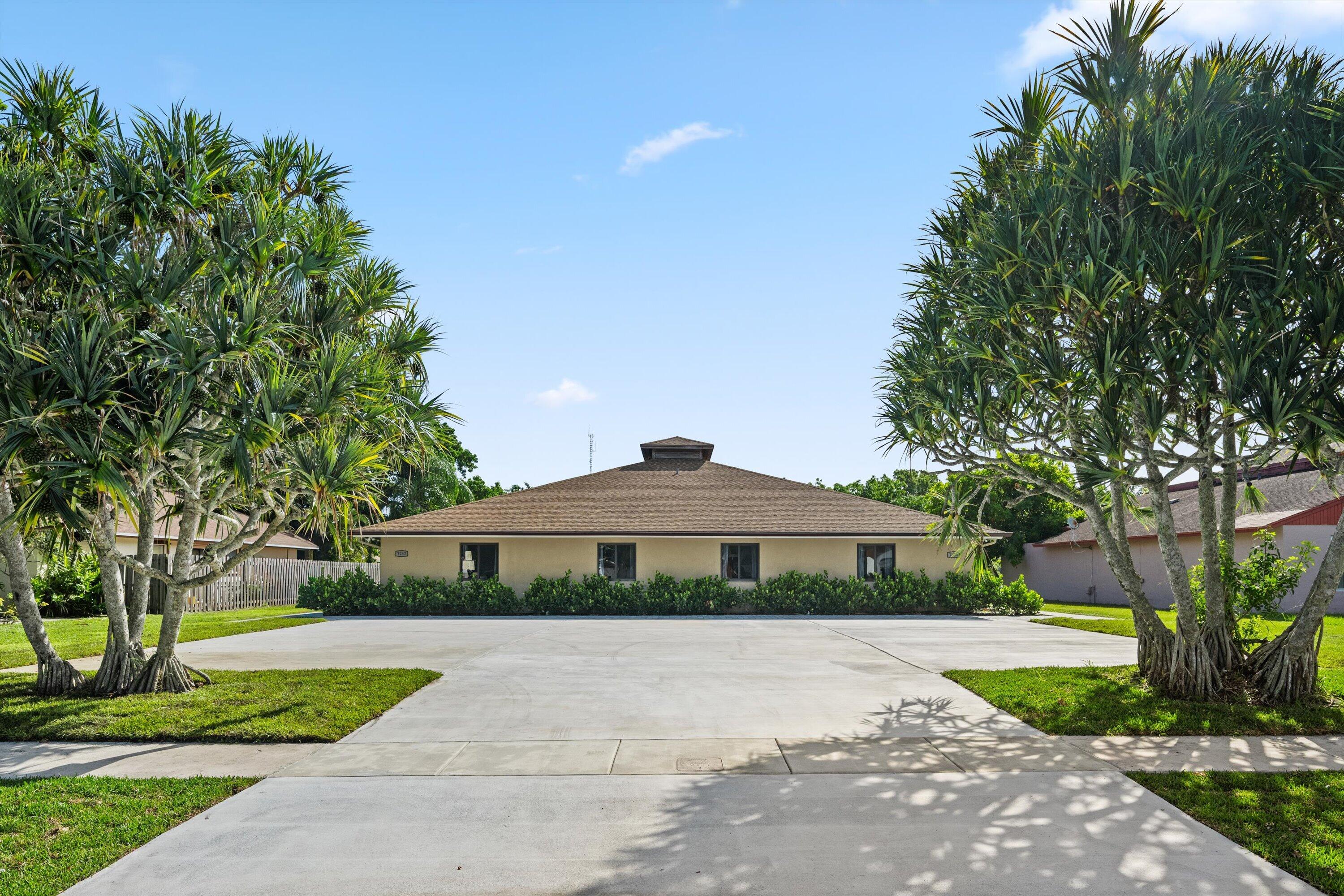 Turnkey furnished fourplex on the 12th Fairway! Four identical 2BR/2BA units, each fully furnished (living room, bedrooms, mounted TVs) with private furnished patios and in-unit combo washer/dryer. Recently renovated with open floor plans and stainless steel appliances. Newly redone driveway/parking area. Quiet, tree-lined street near Wellington's equestrian venues, A-rated schools, and premier shopping. Move-in ready — set rents and start collecting income on Day 1.