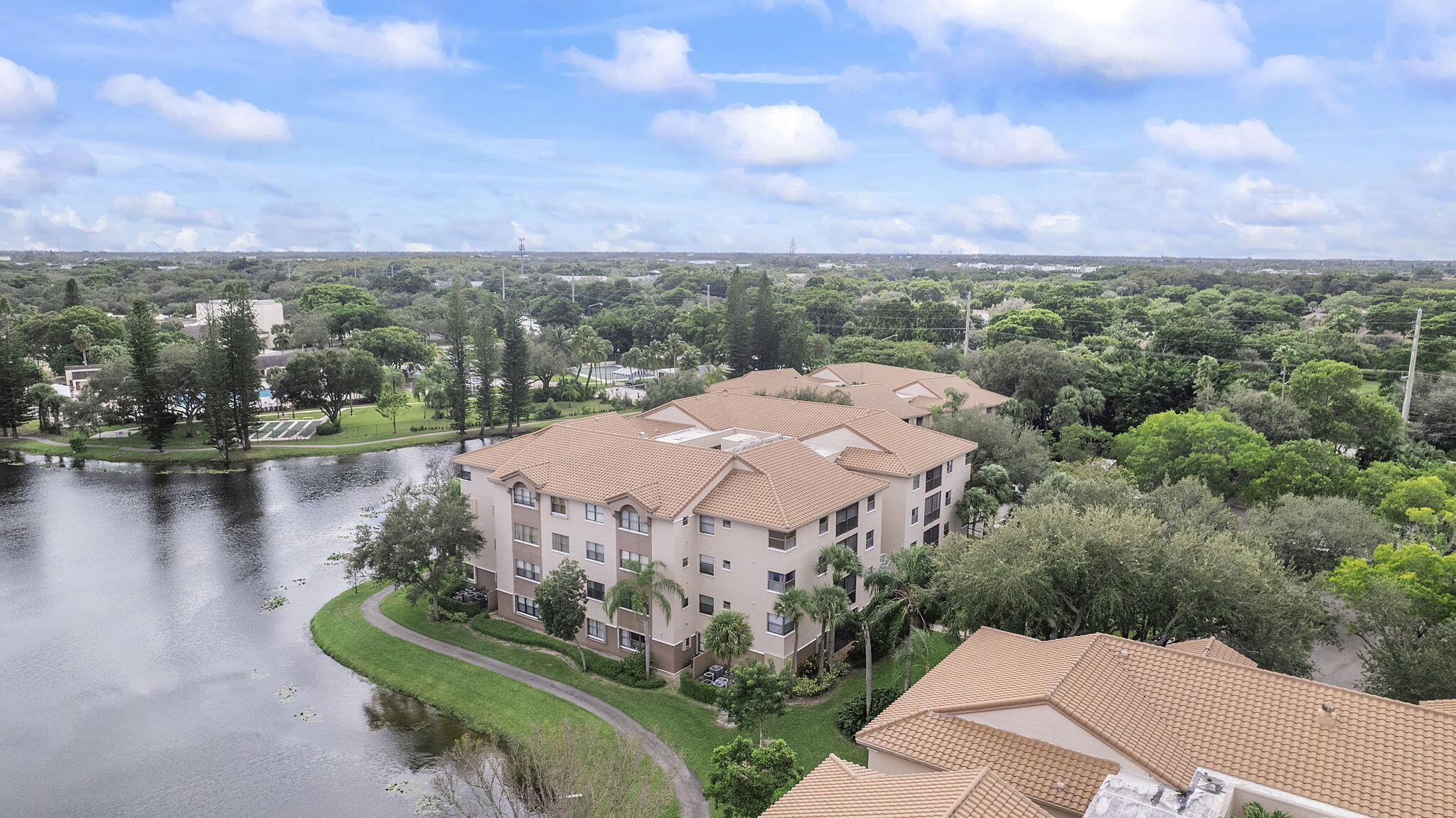 Welcome to this impeccably maintained 3 bedroom, 2 bathroom condo situated on the third floor in the highly desirable Bayport Village. This move-in ready residence features a spacious split-bedroom floor plan with abundant natural light, soaring vaulted ceilings, and fresh interior paint, creating a bright and inviting atmosphere throughout. The home includes a dedicated laundry room with full-size washer and dryer hookups for added convenience. Enjoy relaxing on the private screened-in balcony, perfect for morning coffee or evening breezes. The primary suite offers a generous walk-in closet and an en-suite bathroom with a walk-in shower. Tile flooring extends throughout the unit, providing durability, low maintenance, and a clean, modern aesthetic. Residents enjoy resort-style amenities including a clubhouse, theater, Aquatic Center, fitness center, tennis, pickleball, basketball, racquetball, and more. The monthly maintenance fee includes water, sewer, basic cable, and WiFi. Ideally located just a short walk from the Promenade, offering a variety of shopping, dining, and entertainment options.