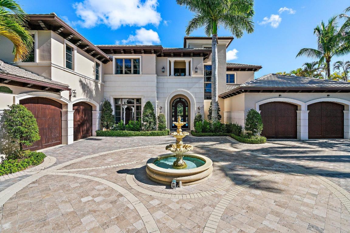 Exquisite two-story estate located in the prestigious Old Palm Golf Club. This exceptional residence offers nearly 7,400 sf of refined, modern living space, set on a half-acre lot with breathtaking golf course views. The home features five bedrooms plus an expansive office, spacious media room, and a total of 6 full and 2 half bathrooms. 

Upon entry, dramatic exterior water features and sweeping golf course vistas are revealed through an entire wall of floor-to-ceiling windows, complemented by soaring ceilings that enhance the home's grandeur. The elegant interior showcases arched doorways, a family room with a sleek modern fireplace, formal dining room, and a temperature-controlled wine room, all accented by stunning marble and luxurious wood flooring throughout, creating a sophisticated yet welcoming ambiance.

The chef's kitchen opens effortlessly to the main entertaining areas, offering a seamless indoor-outdoor living experience. It is beautifully appointed with quartz countertops, double islands, rich wood-beam ceiling accents, a six-burner gas range, premium Thermador appliances, and a built-in Miele coffee maker.  
The first-floor primary suite is a private retreat, featuring custom wood built-in, a tray ceiling, and floor-to-ceiling windows overlooking the beautiful grounds. The luxurious spa-inspired his and her primary bathrooms offer dual custom walk-in closets, spacious glass-enclosed shower, and a soaking tub framed by picturesque garden views.

The first level includes the primary suite, main living spaces, a private office, and a media/club room. The second floor hosts three ensuite bedrooms with a loft or office space along with a separate guest suite with separate access providing ultimate privacy.

Outdoor living is equally impressive, featuring serene golf and lake views, a saltwater pool, summer kitchen, phantom screens, gas fire pit, and striking poolside torches and cascading water elements perfect for year-round enjoyment. Other notable highlights include a private elevator, 4.5-car garage with lifts, and thoughtfully designed spaces ideal for both everyday living and grand entertaining. This home with complete impact windows & modern conveniences seamlessly blends luxury, comfort, and sophistication in one of Palm Beach Gardens' most coveted communities.