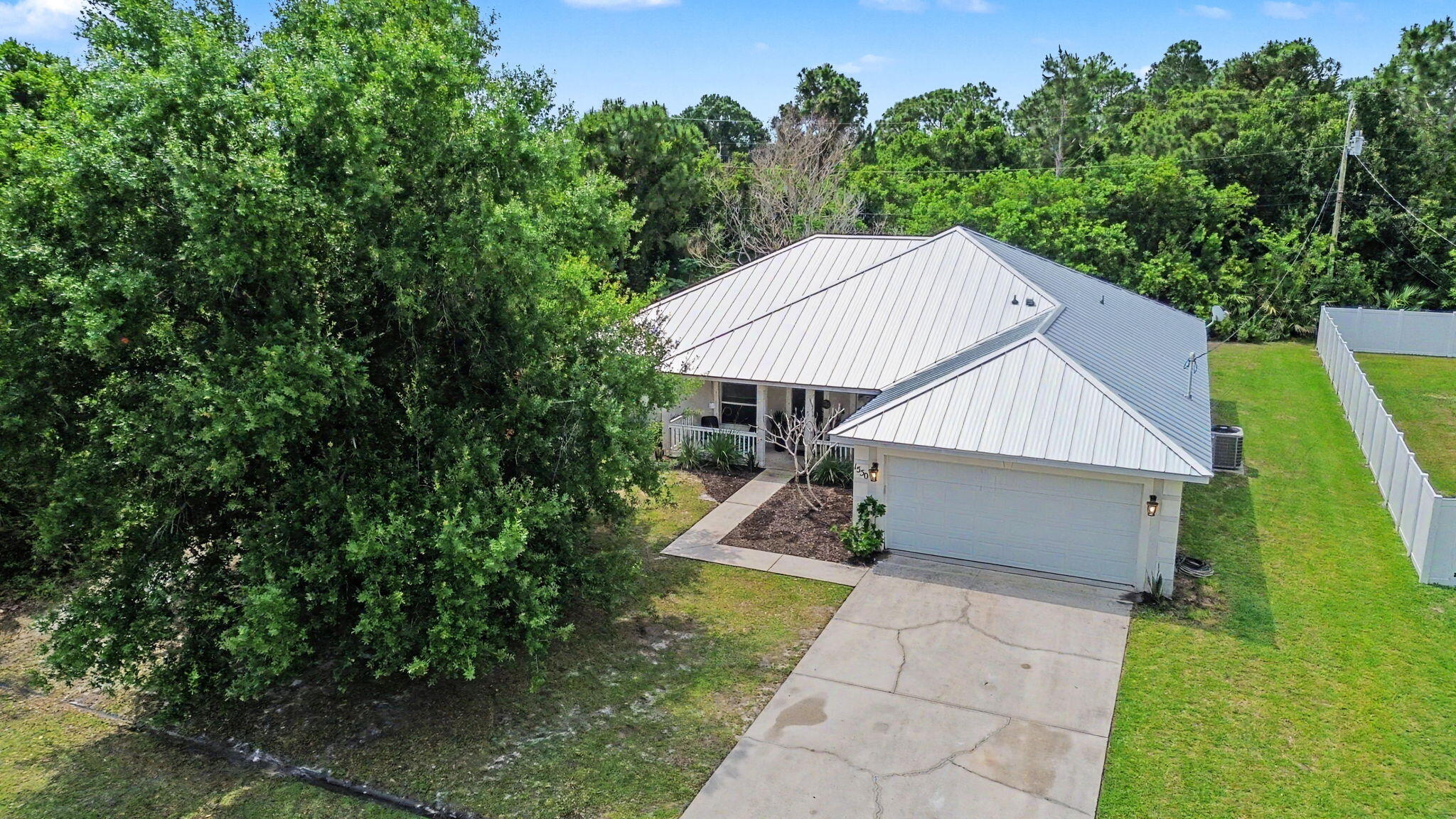 If you are looking for a CBS home in a great location in the southern part of Port St. Lucie, this is it! Great location with over 2,000 sq ft under air. New standing seam metal roof 2023. Move-in ready 3 bed, 2 bath with a versatile floor plan, including a separate formal dining room or living room, and a den at the front of the home! Huge family room with eat-in kitchen area. Large backyard. Vinyl floors throughout and vaulted ceilings. Split floor plan with well-appointed primary suite featuring dual closets, double vanities, and separate shower and tub. Murphy bed in 2nd bedroom, large interior laundry room, upgraded lighting, ceiling fans, and appliances. Front porch and large driveway. Close to shopping, dining, schools, and highways great for commuters. Don't miss this one!