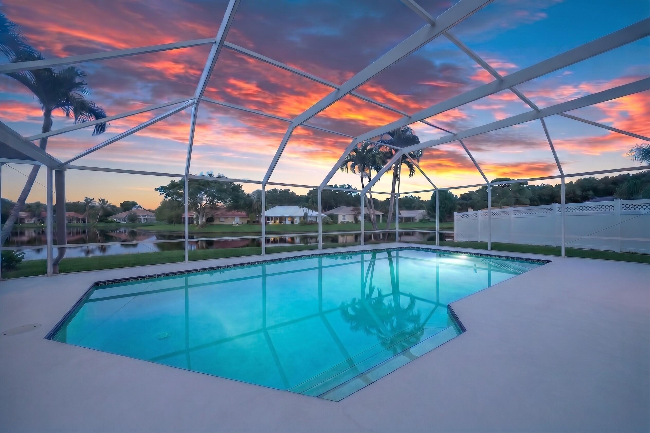 LAKEFRONT - 4 BD, 2.5BA  w/Impact Glass, fresh paint, AC's ('21) & screened pool & patio on a private cul-de-sac in The Shores of Jupiter. Premium waterfront lot w/ LONG lake views and a sprawling backyard beyond the pool. Inside, natural light, rich wood floors and a floor plan that flexes w/ you. A living room w/bay windows, formal dining room seating 10 and family room w/fireplace, wet bar and 4 sets of French doors to the pool and patio make up the living areas w/ the kitchen at its heart so you never miss a moment and can enjoy lake views. Upstairs, 3 guest bedrooms (2 w/ Walk-In Closets) are served by a full bath w/ 2x vanity & the Master Bedroom is massive, w/ trey ceilings, 2 - walk-in closets, lake views, soaking tub, sep. shower, wtr. closet and 2x vanity. Generator, 2+ Car. Gar. Presenting a custom built  & freshly painted, 4 bedroom, 2.5 bathroom, two story home w/ updated AC Units ('20 & '21), IMPACT GLASS and a newly screened ('24) pool on a cul-de-sac surrounded by the tranquil waters of the coveted, Shores of Jupiter. With 124' of lake frontage and a shoreline easement beyond that, this .20 acre premium lot lives like a half acre with long lake views in three directions. The home itself is gorgeous from the quiet cul de sac with fiber cement siding wrapping all four sides, oversized impact windows and a leaded glass double door entrance. Inside, you're greeted by a two story foyer w/ coat closet, the large windows allow natural light to dance across the rich, wood floors found throughout the home. At left, a spacious living room, with bay windows and vaulted ceilings guides you to the formal dining room (separated by a half wall) where you'll find near floor to ceiling windows and a space capable of comfortably hosting a table for 10. Next, a pocket door separates the dining room from the kitchen, the heart of the home offering both pool and lake views. It is equipped with an island w/ storage & dishwasher, dual sinks, a pantry, solid wood cabinets, stainless steel refrigerator & range/oven. Ahead, the magic of this property begins to reveal itself as panoramic lake views filter through multiple sets of French doors into the breakfast area and the Family Room - here, the feeling of "home" is defined - soaring ceilings, a wood burning fireplace with crisp white mantle contrasting against a red brick, wall-to-wall hearth.. With a wet bar steps away, just add friends and this will become the setting for memories you'll cherish most. Outside, a unique covered patio with cathedral ceilings is tucked between a fully fenced side yard (perfect for even larger pets) and your gorgeous pool in immaculate condition, protected by a NEW screen enclosure (2024) while outside the enclosure, gorgeous palms frame those tranquil lake views and you will find plenty of space for solace or to practice any team sport. As the sun sets, head back inside and allow rich wood steps and freshly painted white risers guide you upstairs. Here you'll find all 4 bedrooms. Two of the three guest bedrooms offer extraordinary lake views, one with a standard closet, the other a walk-in closet while the third bedroom offers a walk-in closet -- all guest bedrooms are larger than you'd expect and are served by a full bath located in the hallway with dual sinks, a tub/shower combo and built in cabinets. Ahead, the master bedroom, with trey ceilings and windows facing an incredible 3 directions, West, South and East over the lake. The space will accommodate the largest bedroom set and even a sitting room or gym area. The master bath is found just beyond a pair of walk-in closets, it features a jetted tub below a glass block wall, water closet, separate shower and dual vanity. As a custom built home, there are well thought out features that complete the home such as, under stair storage, an over sized two care garage with extra storage room, generator hookup and portable generator, a large lakefront laundry room with Kenmore Elite Washer & Dryer, two updated AC units ('20 & '21), outdoor shower, an office nook or coffee bar off the kitchen, mature landscaping and so much more.  18862 Loblolly Pine Court is one of The Shores' crown jewels and The Shores itself is one of Jupiter's most coveted neighborhoods that benefits from A-Rated schools, a low, no-nonsense HOA with parks and sidewalks that wind through enchanting oaks and sparkling lakes. Residents enjoy a simple commute for work North or South, or travel the world via Palm Beach International Airport, just 25 min. away. Jupiter is known as a "small fishing village" yet offers world class dining, beaches, a dog beach, recreation, shopping, entertainment and more with new, exciting developments every year and head turning celebrities at every corner. It is no wonder Jupiter was named one of Coastal Magazines "Happiest Seaside Towns"... so schedule a private showing today, this property must truly be seen to achieve a full appreciation.