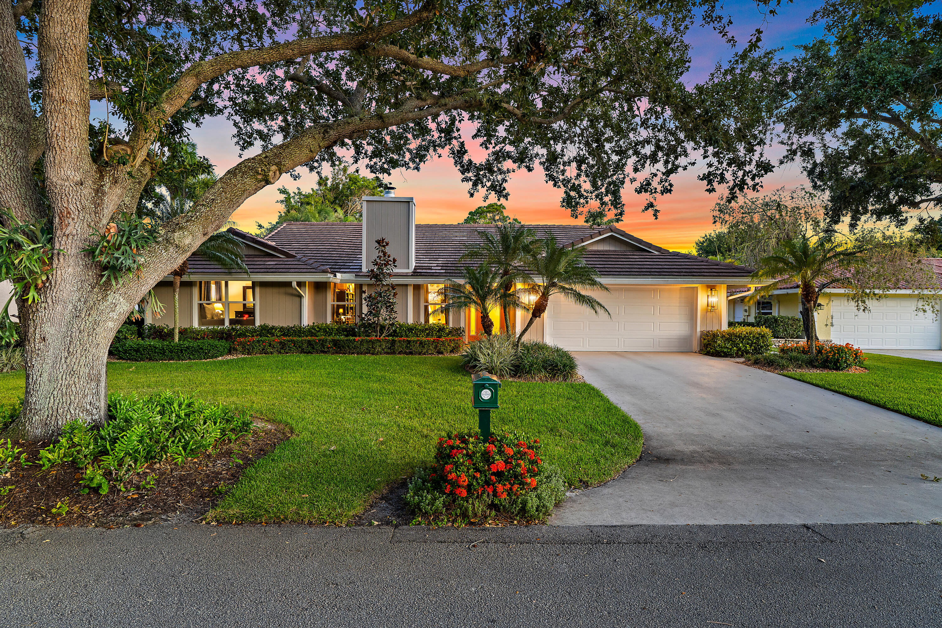 Nestled on an oversized, beautifully landscaped lot in the highly sought-after Glengary community within PGA National, this immaculate residence offers the perfect blend of luxury, comfort, and privacy. Over 2,000 square feet of thoughtfully designed living space, the home features three spacious ensuite bedrooms, three full baths, and an additional powder room, providing an ideal layout for both everyday living and entertaining.  Step inside to soaring volume ceilings and an abundance of natural light that enhance the home's open, airy feel. Luxury vinyl plank flooring flows throughout the living areas, complementing the home's refined yet comfortable design. The updated kitchen is both stylish and functional, featuring upgraded cabinetry, updated countertops, and a suite of appliances  installed within the past year. Whether hosting guests or preparing a quiet meal at home, this beautifully renovated space serves as the heart of the residence.  Each bedroom offers the privacy and convenience of its own ensuite bath, while the updated bathrooms showcase tasteful finishes and modern appeal. Meticulously maintained and truly move-in ready, the home also offers the peace of mind that comes with a 2022 roof, 2020 HVAC system, and impact glass protection.  Outdoor living is equally impressive. Surrounded by lush tropical landscaping, the private backyard retreat centers around a stunning 36' x 14' heated pool with an impressive 8-foot depth, creating the perfect setting for relaxing, entertaining, or enjoying South Florida's year-round sunshine. The oversized homesite provides exceptional privacy and a tranquil atmosphere rarely found within a community setting. Impact glass windows with the exception of two block glass windows which have panel protection.  Located within the renowned PGA National, residents enjoy a premier Palm Beach Gardens lifestyle with world-class golf, exceptional dining, upscale shopping, and beautiful beaches all just minutes away. Combining timeless updates, major system improvements, and a spectacular outdoor oasis, this exceptional home is a rare opportunity not to be missed. Membership at PGA National is voluntary.