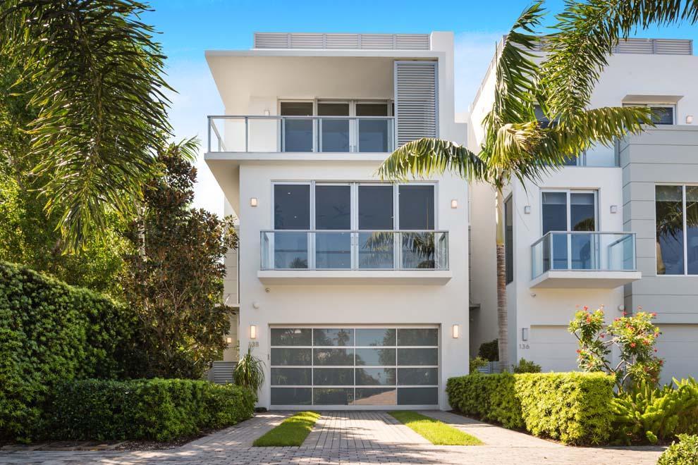 This stunning direct Intracoastal townhouse offers the very best of coastal living with the perfect blend of a modern design and an inviting casual sophistication. Professionally staged by Ava Gray Interiors, this tranquil corner residence boasts abundant privacy with 7,200 total square feet, four bedrooms plus office, spacious living areas, private pool, rooftop terrace with summer kitchen and sensational views of the waterway and lush landscape. Additional features include fireplace, elevator, impact windows and doors, custom finishes, private side yard and two-car garage. Seagate Yacht Club is a private enclave of waterfront townhomes located just two blocks from the Atlantic Ocean and the boutiques and eateries along Atlantic Ave. Enjoy the serenity and luxury of South Florida living. FEATURES:
" Fabulous location just two blocks from beach and East Atlantic Avenue
" 4 bedrooms plus office / 4.1 baths
" 4,568 square feet under air / 7,247 total square feet
" Built in 2016
" Designed by Richard Jones Architecture and Built by Seaside Builders
" High-end finishes and custom lighting throughout
" Desirable corner, end location with private side yard 
" Decorative paver driveway and walkway to gated entry with fountain
" Foyer entry with stunning glass door showcases modern design, impressive stairway with abundant natural light, volume ceilings and hardwood floors
" First floor hallway leads to waterfront en suite guest bedroom/den and private waterfront office both overlooking the pool; elevator; garage; large laundry room; and storage room with doorway to side yard
" Second floor landing leads flows to living areas, guest bedroom and stairway to third level
" Open living room, kitchen and dining room with walls of sliders to balcony overlooking the marina and Intracoastal Waterway
" Modern kitchen with top-of-the-line appliances including gas range; large island with snack bar seating; second refrigerator tucked in under-stair location; and abundant counters, cabinets and storage
" Living room features linear fireplace and additional private sitting area with powder room and elevator access nearby
" Dining room is open to kitchen for easy entertaining while enjoying the stunning water views
" Second level east en suite bedroom with walk-in closet and private balcony
" Third level master wing offers spacious bedroom with private balcony and water views; separate room perfect for gym, office or sitting area with private balcony; spacious walk-in closet; and master bath with dual vanities, large custom double walk-in glass shower and linen closet
" Third level en suite guest bedroom with walk-in closet
" Third level hallway with elevator access and laundry closet
" Rooftop Terrace with summer kitchen, gas fire pit, and abundant space for outdoor lounging and dining while taking in the sunrise and sunset views
" Private side yard and pathway that leads to heated salt-water pool with sun shelf and covered patio with automated screens for indoor/outdoor living.
" Decorative driveway with two-car garage and custom garage door; decorative path to front entry and gate to private side yard and pathway to pool
" Amenities include wood floors; impact glass windows and doors; generator; four-stop elevator; tropical landscape for privacy and lovely backdrop; linear ac diffusers; two laundry rooms; natural gas; two-car garage; and lots of storage.
" Professionally staged furnishings can be purchased separately through Ava Gray Interiors